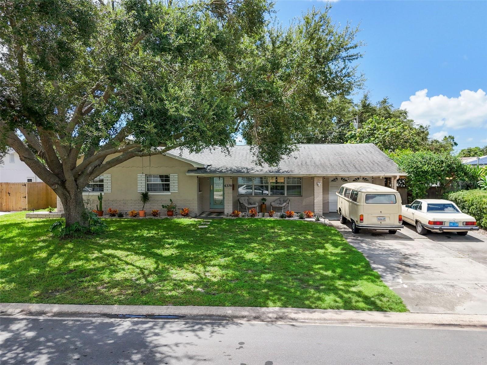 Step in to retro cool with updates for today's living. Amazing mid-century ranch in the sought-after Holiday Park neighborhood of St. Petersburg, offering stylish updates and timeless charm. The kitchen has been beautifully refreshed with open shelving, new herringbone butcher block counters, and an opened-up half wall that creates a seamless flow into the living space. A sunny window fills the room with natural light, making it the perfect spot to cook and gather. Both bathrooms have been recently renovated with new vanities, tile, and fixtures for a fresh, modern feel.
Luxury vinyl plank wood floors run throughout the home, adding warmth and durability. A cozy step-down family room overlooks the backyard and is filled with light, creating a welcoming space for relaxation. The open floor plan enhances the sense of space, while refreshed landscaping adds to the home’s curb appeal. Enjoy evenings on the front covered porch or host gatherings on the back patio, surrounded by a spacious yard.
This Holiday Park gem is move-in ready and perfectly blends mid-century character with modern comfort.