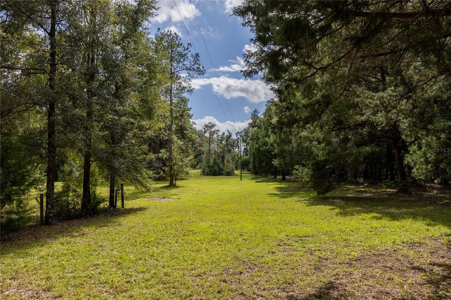 Endless Possibilities on 6.5 Acres of Peaceful Country Living. A rare opportunity to own 6.5 acres of beautiful, unrestricted land surrounded by nature. With no HOA, you have the freedom to bring your vision to life — whether that’s building your dream home, creating a mini farm, or simply enjoying wide-open space and privacy. This is a vacant land listing with a structure on it but the value is in the land. The existing home is a tear-down, offering a clean slate for your perfect design. Imagine waking up to the sound of birds, watching the sunrise over your acreage, and ending the day with a sky full of stars. If you’ve been searching for land with potential, peace, and freedom, this is the one. Just under 4 miles to downtown Alachua and 19 miles to UF's main campus. This property is cross listed as a Residential Listing: MLS # GC535106