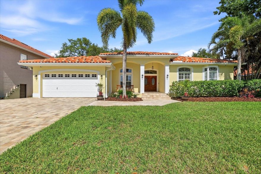 Beautifully updated 4-bedroom, 2-bath pool home in the heart of Tarpon Springs featuring the ultimate backyard entertainer’s paradise! From the moment you arrive, you’ll love the beautiful landscaping, paver driveway, paver front walkway and porch, double door entry, sidewalks throughout the community, and the added benefit of Flood Zone X with no HOA.  Designed for both comfortable family living and entertaining, this home offers a caged pool/patio area with heated saltwater PebbleTec pool and spa, travertine decking, built in outdoor kitchen with gas grill, and fire pit — creating the perfect private outdoor retreat. Inside, you’ll find a spacious kitchen with breakfast nook, high ceilings, hardwood and tile flooring throughout, plantation shutters, stainless steel appliances, granite kitchen countertops, ample counter space and kitchen storage, indoor laundry room with wash sink, and sliding glass doors that seamlessly open to the outdoor living space. The oversized primary suite features 2 walk-in closets and a beautifully remodeled bathroom. Additional highlights include a 2021 A/C system, barrel tile roof 2014, and 2-car garage.  Ideally located near the Tarpon Springs Sponge Docks, Fred Howard Park, Sunset Beach, the Pinellas Trail, shopping, dining, highly rated schools.  Experience what the greater Tampa Bay area has to offer with nearby Gulf beaches, professional sports, theme parks, and attractions — this home offers the perfect blend of family living, entertainment, and the Florida lifestyle.
