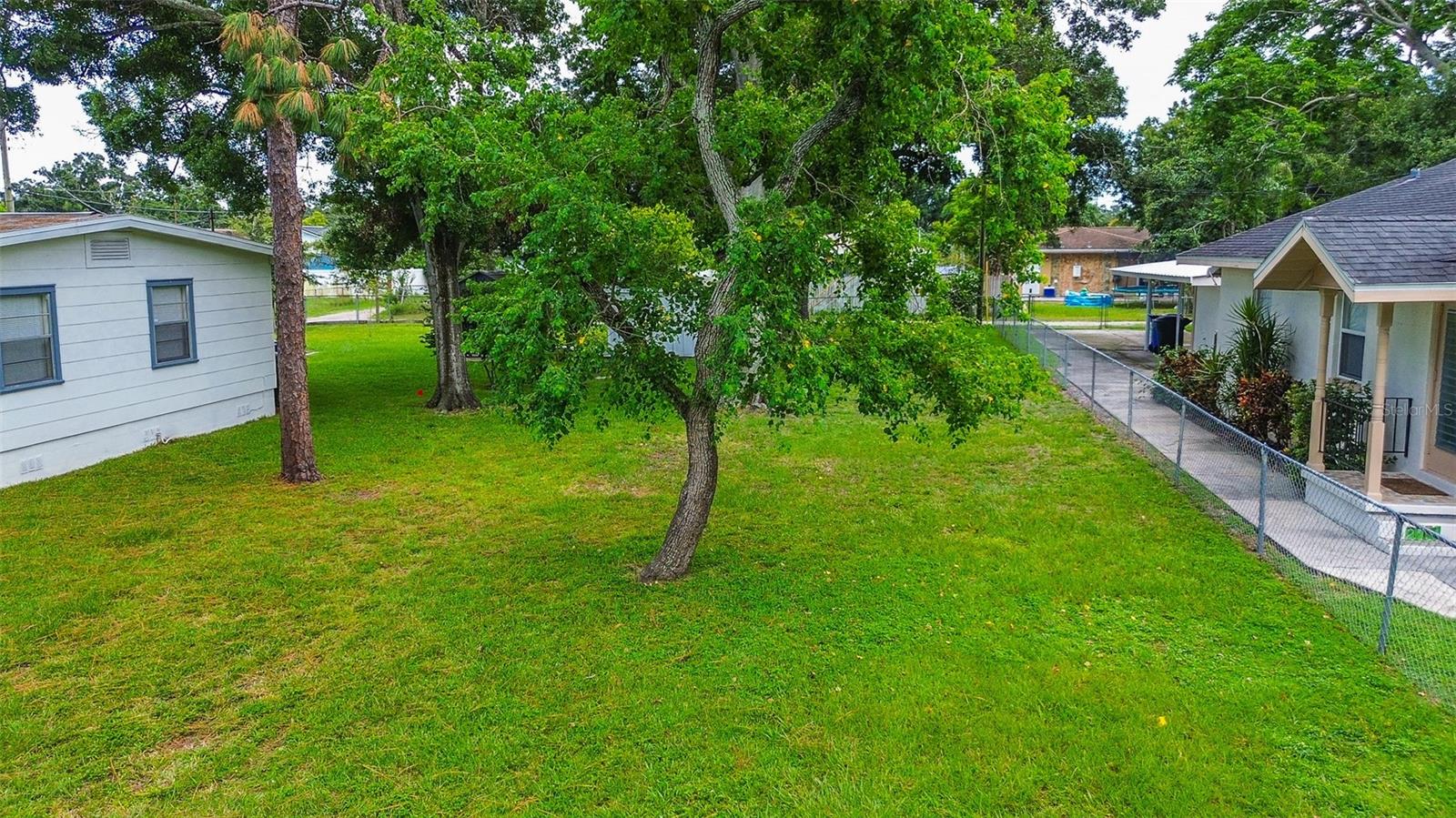 Prime .13 acre lot in the Clear Vista neighborhood of St. Petersburg, FL, perfect for building your dream home or a lucrative investment property. NSM-1 flexible zoning allows for single-family or multi-family development (please verify zoning and uses with the City of St. Petersburg). The property is not in a special flood hazard area (zone X) and all utilities are available at the street. Sidewalks are already in place. This 125 ft. deep lot is surrounded by a chain link fence. Enjoy street or alley access and easy access to local amenities, like schools, parks, and shopping. Currently the single-family homes on both sides of the lot are for sale. This is a rare opportunity to buy a home with a vacant lot next door to double the size of your property! Don't miss out. Call for an appointment today!