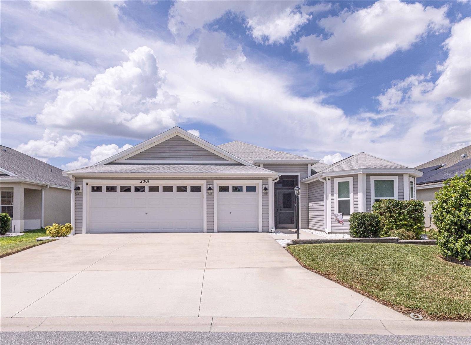 Welcome to your dream home in the heart of The Villages! Tucked among scenic oak-lined trails near The Village of Fenney, this exquisite Begonia model offers the perfect blend of comfort, elegance, and modern living.Built in 2019 with recent updates, this 3-bedroom, 2-bathroom home boasts over 2,260 sq ft of spacious living. The open floor plan is highlighted by tray ceilings, stainless steel appliances, and a 2-car garage plus a golf cart garage.One of the standout features of this home is the enclosed lanai, complete with a new mini split unit and motorized shades, expanding your living space for year-round enjoyment—perfect for relaxing or entertaining. The open-concept kitchen is a chef's dream, featuring dark cabinets, stainless steel appliances, and an abundance of counter space. The Master Suite is a true retreat, offering his-and-her walk-in closets, plus an additional closet for extra storage. The luxurious ensuite bath includes a Roman walk-in shower, dual vanities, and a separate area for the toilet, ensuring added privacy.The split-bedroom floor plan ensures privacy, with two additional guest bedrooms located on the opposite side of the home, sharing a full bath with a tiled shower/tub combo.Location, location, location—this home is ideally situated with easy golf cart access to some of the best attractions in The Villages. A short ride takes you to Magnolia Plaza and the Everglades Recreation Area, where you’ll find a wide range of dining options, restaurants, and activities. Centrally positioned, you’re also just minutes from Brownwood, Sawgrass, and the newly opened Eastport Squares (Opening Soon), offering even more shopping, dining, and dancing. Plus, living in The Village of McClure means you’re just moments away from the Loblolly Executive Golf Course and the Willow Tree Postal & Rec Center. Call today to schedule your private tour.