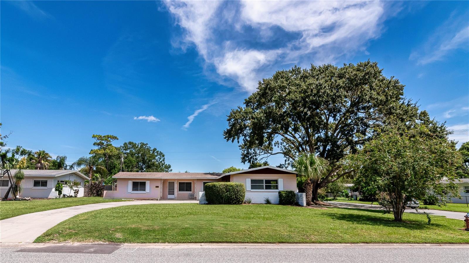 Excellent value on this classic ranch-style home in the well-established Kingswood Manor neighborhood. Recent updates: new roof (2019), fresh interior paint and brand-new range and microwave. You’ll be impressed as soon as you arrive - great curb appeal – meticulously landscaped corner lot. The front entry brings you into the heart of the home – oversized living room that provides access to a Florida room out back. Notice the terrazzo flooring – continues throughout much of the home. Continuing across the front you’ll find your prep kitchen and formal dining room. Split bedroom plan with primary suite on one side – ideal for privacy. Bedroom is generous in size, has two closets and direct exterior access. Here you’ll find a cozy ensuite bath w/shower. Secondary bedrooms/bath are tucked off the home’s hallway, and the back bedroom has direct access to the screened lanai. The backyard is partially fenced, and the lanai and Florida room overlook this part of the yard. You’ll appreciate the handy shed back here, too. The oversized carport will fit two vehicles, and you can drive in from the side street as well as the front of the home. Here you’ll also find storage space that will accommodate your laundry hook-up. Great location – no HOA and about a 5-minute drive to I4, John Young Parkway, and essential shopping spots. This home was lovingly cared for by the same family for decades. Now is the time for you to come in and make some new memories. Great deal; come see all that this home has to offer!
