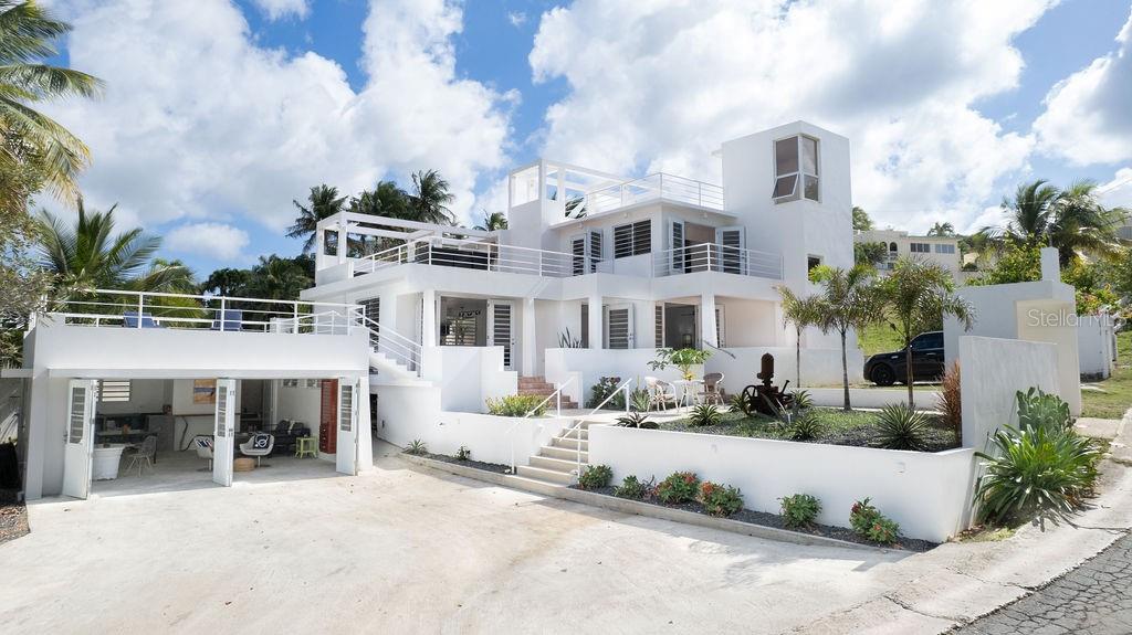 Casa Solsticio is a gem situated just steps away from La Chata beach in Bravos de Boston. Inside, the ocean’s presence and refreshing cross breeze can be felt from every corner. Each space masterfully interconnects with an outdoor balcony or terrace, doubling the size of the living quarters and allowing natural light to flood the interiors.
With it’s clean geometric lines and saltillo tiles, the principal structure’s architecture has a western mediterranean look, similar to that of the Bealearic Islands. The first level has an ample commercial style kitchen, dining room, and living room with a street-side porch, spacious enough for a outdoor seating and lounging. The principal bedroom has an ensuite bathroom with an outdoor shower and is adjoined to a private solarium terrace that has a solar powered lap pool shaded from the afternoon sun.
On the second level is a full private loft with an open concept living room, bedroom, private bathroom, and a generous walk-in closet. The loft has both a balcony and a spacious terrace with a full outdoor kitchen and dining area. Above, a rooftop promenade has amazing views of the turquoise waters. Electricity connections are also available to light up the space and add music for rooftop cocktail parties.
Adjacent to the principal house is a separate studio apartment with a full kitchen, bathroom dining, living, and bedroom spaces. The studio also has it’s own rooftop terrace so guests can enjoy soaking up the rays or the starry nights.
Located in a quiet residential street that is just a five minute drive to the ferry and downtown. The home is tastefully furnished, is equipped with AC in all the spaces, and has a laundry area. With two carports that have space for up to five cars, this is the perfect home for living and hosting.