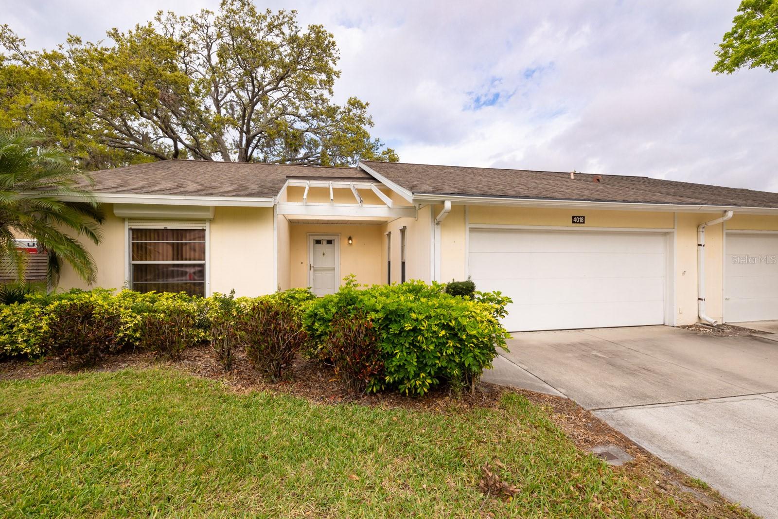 Oakhurst Villas are located in a lovely 55+ community with beautifully, well maintained landscaped lawns and fabulous trees everywhere. This 2 bedroom, 2 bath unit has a great layout that includes a wide open living space, private master suite and super closet and storage space throughout the home. In addition, just outside the spacious kitchen area is a very cozy, nicely lit spot to be used as an office, study, craft room, etc. Solar tubes and hurricane shutters have been added in addition to a new water heater in June of 2024, new air handler in April of 2020 and kitchen appliances replaced in 2021. In addition, this is one of the goodies with a 2 car garage giving you an extra 170 sqft of space! This cozy community features a clubhouse, pool, library, shuffleboard, billiard table and more. In addition to all of the Villa goodies, the location is fabulous for dining, entertainment, shopping, famous Siesta Key, Hwy. 75, Sarasota and Bradenton International Airport and the list goes on. Don’t miss this opportunity to be in the middle of this awesome community.