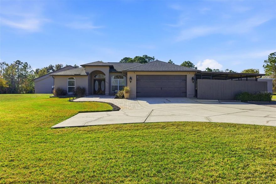 Exceptional opportunity in Wesley Chapel. This one-owner, rare and versatile 1.6-acre property zoned AG features a gated entrance with a fully fenced yard and offers two beautifully designed homes, ideal for multigenerational living, rental income, or a private compound, while enjoying the freedom of NO HOA and NO CDD fees.

The 2,018 sq. ft. main residence offers three bedrooms and two bathrooms and has been extensively updated. The home was painted in 2025 and features new WINDOWS in 2021(double-pane argon gas-filled) sliders, a back door, and a new ROOF in 2021. The new KITCHEN 2025 showcases quartz countertops with a waterfall edge, soft-close custom cabinets (pull-out shelves in base cabinets), undercabinet lighting, and a touchless faucet, and includes an induction range, microwave, dishwasher, refrigerator, and full-size stackable NEW WASHER & DRYER 2025. The Primary bath was updated in 2020 with a large, dual-head shower featuring glass doors and accented by a barn slider entry door, and a new LAUNDRY room in 2025 includes cabinets. Additional living space includes a 20x50 screened recreational room, ideal for year-round enjoyment.

Outdoor living is exceptional with new OUTDOOR LIVING 2022, featuring a paved 25x50 lanai with an outdoor kitchen complete with a grill, side burner, exhaust hood, refrigerator, sink, under-counter cabinets, and granite countertops, plus a gas fireplace with mantle and 65-inch television. The 24? round pool area includes a large paved deck and white sand sunning area, gazebo, covered outdoor shower with hot and cold, sundeck, and low-voltage lighting throughout, creating a private resort-style setting.

Additional upgrades include a front sprinkler system, low-voltage lighting, a paved entryway, a new TANK & WELL PUMP in 2021, a new WATER SOFTNER system in 2023,  a gas TANKLESS WATER HEATER in 2021, and hardwired security systems with cameras for added security.
The secondary home offers 1,500 sq ft of beautifully designed living space with three bedrooms, 1 full bath, and one-half bath that was freshly painted in 2025. It features a new METAL ROOF 2025, a new gas TANKLESS WATER HEATER in 2021, a new JACUZZI TUB 2024, and a new 2024 BALCONY DECK with a custom handrail overlooking the pool. The home includes a fridge, microwave, range, and surround sound system, making it perfect for guests, extended family, or income potential.

The property also includes a 40x60 detached garage, inside you will find RV parking with hookups, and an impressive 40x30 open WORKSHOP featuring a 9,000 lb lift, a 20x30 air-conditioned recreation room with tiled floor, a 20x30 enclosed workshop, and 220 power with 50-amp service, offering endless possibilities for hobbyists, business owners, or collectors.  The expansive property offers ample space for a variety of uses, including the ability to keep farm animals (chickens & turtle not included) or horses, create a small homestead, or enjoy room for workshops, recreational equipment, or other hobbies. With no HOA restrictions, the land provides flexibility and freedom rarely found, allowing you to truly tailor the property to your lifestyle.

Conveniently located with multiple access points to Interstate 75, this property is just minutes from the brand-new Target, The Grove, movie theater, restaurants, shopping malls, children's hospital opening late 2026, two nearby hospitals, and more.