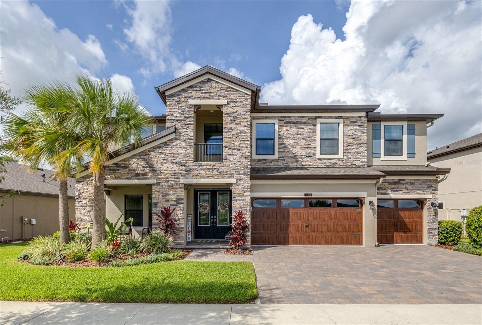 Experience luxury living in the heart of Connerton. Nestled on a serene pondside lot, the Virginia Park floor plan by Homes By WestBay offers the pinnacle of modern luxury. With breathtaking views and an expansive layout, this home boasts 5 bedrooms, 4 full bathrooms, an oversized upstairs loft, and high-end finishes throughout — all designed to impress.
The charming Tuscan-inspired exterior, with elegant stone accents and warm earth tones, welcomes you home. Timeless architecture is paired with lush landscaping, enhancing both curb appeal and tranquility. A cozy covered front porch invites you to unwind and enjoy the peaceful beauty of the neighborhood.
Upon entering, you’re greeted by glass-enhanced front doors that flood the entry with natural light. The space flows seamlessly into a versatile Flex Room, perfect for a formal dining area, home office, or playroom — the choice is yours.
As you continue through the home, the gorgeous kitchen awaits. Designed for both style and functionality, it’s truly a culinary haven. High-end quartz countertops provide both luxury and durability, while a breakfast bar with pendant lighting and extended cabinets provide extra storage. Top-of-the-line GE Profile stainless steel appliances — including a gas cooktop, SS hood, built-in oven, and microwave make meal prep a breeze.
The great room, the heart of the home, is perfect for entertaining or cozy family nights. The open flow to the kitchen and dining areas creates an ideal space for gatherings of all sizes. Step through extended glass sliding doors that bring the outdoors in, offering panoramic views of the pond and your private retreat. The inviting pool area, featuring a heated saltwater pool, is perfect for relaxing or entertaining in style. Additionally, pre-plumbing for an outdoor kitchen is already in place, allowing you to easily create your dream outdoor cooking space for al fresco dining.
Completing the downstairs is a full bedroom and bathroom, ideal for guests or multi-generational living. With direct access to the pool area, it’s the perfect retreat after a day of outdoor relaxation.
Upstairs, you’ll find three additional bedrooms plus the master suite, each featuring ample space and walk-in closets. The master bedroom, with its elegant double-door entrance, offers an elegant escape. The oversized bonus room serves as a versatile retreat, perfect for movie nights, a game room, or additional living space. A conveniently located laundry room on the second floor adds ease and practicality to everyday living, eliminating the need to carry laundry up and down the stairs.
Whether you're hosting family and friends or savoring quiet moments by the water, this home provides everything you need for comfort, elegance, and relaxation. More than just a home, this is a lifestyle — one where luxury meets leisure. Come experience The Virginia Park and discover how this lakeside oasis can become the perfect backdrop for creating lasting memories with your family.
Beyond the impressive walls of the home, the community enhances your lifestyle with resort-style amenities, including a pool & splash park, clubhouse, coffee shop, fitness center, basketball courts, tennis courts, volleyball, nature trails, and playgrounds — all designed for your enjoyment.