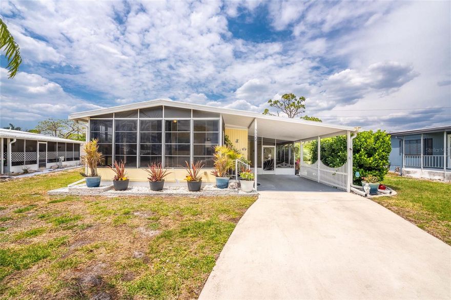 In Sandalhaven Estates, a 55+ pet friendly community in Englewood where you own your land, this updated 2 bedroom, 2 bathroom home with carport and an open concept floor plan offers an easy, comfortable way to enjoy Florida living. Being sold furnished and ready to go, it features a 2022 roof, newer mini split A/C systems, and new luxury vinyl plank flooring throughout, giving you peace of mind right from the start. Inside, the home flows naturally from one space to the next, creating a bright and welcoming feel. The family room is open and inviting with updated flooring, chair rail detail, and connects to the dining area with built-in cabinetry and a fantastic coffee and wine bar. The kitchen sits at the center of it all with plenty of white shaker style cabinets, stainless steel appliances, Formica countertops, and an island with bar top seating that makes everyday living and entertaining feel effortless. The ensuite primary bedroom offers a comfortable retreat with great natural light, a walk-in closet, and a step-in shower. The guest bedroom is nicely sized with a reach-in closet and the guest bathroom with tub/shower combo is thoughtfully positioned for privacy while still feeling connected to the home. The enclosed front sunroom brings in that relaxed lifestyle, offering an additional living space with heat and A/C so you can enjoy it year round, whether you are starting your morning with your favorite cup of coffee or winding down in the evening with a cocktail. The screened carport lanai creates another inviting area to sit and enjoy the outdoors, with access to the backyard where you will find a great shed for storing the golf clubs and beach toys and laundry hookups for added convenience. Throughout the home, you will find updates that make a difference, including newer appliances, fresh paint, and a clean, modern look that carries from room to room. Outside, mature landscaping, added backyard privacy, and space between homes create a setting that feels both open and peaceful. Beyond the home, Sandalhaven Estates is a well-kept community of just 84 homes with spacious yards, mature trees, and two small lakes that attract tropical birds and add to the peaceful, Old Florida feel. With no clubhouse or pool, the community keeps expenses low while still maintaining the grounds, and the Charlotte County public pool on San Casa Avenue is just a short drive away. With beaches, boating, fishing, golf, restaurants, and shopping all just minutes away, this location makes it easy to enjoy everything Englewood is known for. Homes like this, with land ownership and this level of updates, are hard to find, making 3022 Audubon Avenue a great opportunity to step into the Englewood lifestyle.