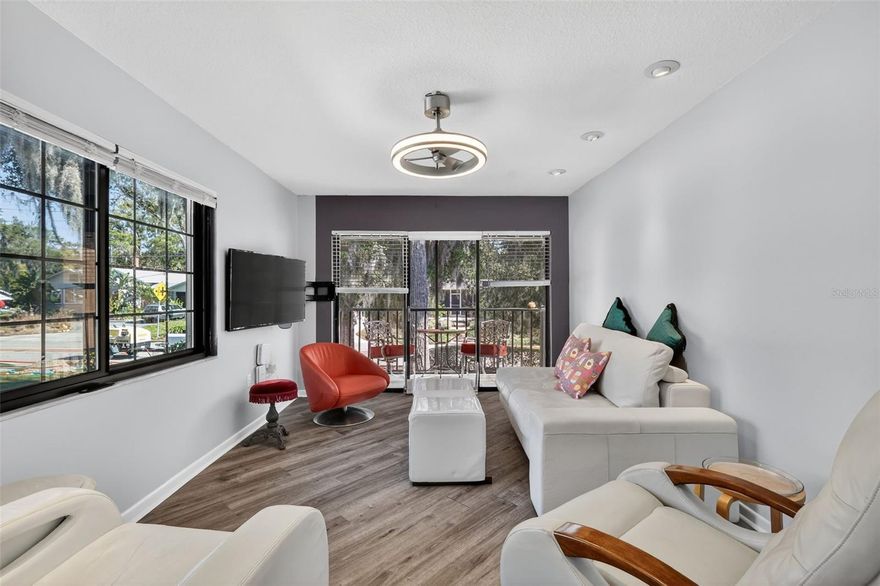 Welcome to 225 E 10th Ave., in the heart of Mount Dora, where charm and modern, blend seamlessly. Nestled in the intimate 10-unit community of Dora Arms, this light-filled second floor corner unit presents an exceptional opportunity for those seeking a lifestyle enriched by walkability and artistic vibrancy. Just five blocks from historic downtown and shimmering Lake Dora, this condo offers direct access to the Tremain Street Greenway, Mount Dora's bicycle and pedestrian trail, ideal for leisurely strolls or invigorating rides.

Step inside to discover a sanctuary of style and comfort. The private screened lanai invites you to savor your morning coffee or enjoy evening people-watching amidst the lush surroundings. The home features two beautifully updated bathrooms with modern amenities, including LED makeup mirror lighting, handheld shower wands, and a heated floor in the primary bath for those cooler mornings.

The kitchen's renovation includes rollout cabinet drawers, a pullout spice rack, and premium appliances like the induction cooktop and 7-mode oven, all complemented by under-cabinet lighting and a sleek granite sink. The living areas and bedrooms feature low-profile LED fanlights, recessed downlighting, and window treatments, creating a warm and inviting ambiance.

Vinyl flooring in the bedrooms and a striking custom diagonal pattern in the great room add a touch of elegance, while the utility room, equipped with a heavy-duty washer and dryer, enhances convenience. This move-in-ready unit also provides attic storage and a covered parking space directly underneath, with additional guest parking available. 

Immerse yourself in Mount Dora's celebrated arts and festival scene, with its vibrant downtown full of unique restaurants, boutique shops, and art galleries. Enjoy year-round events like the Mount Dora Arts Festival and regular wine walks, all of which contribute to the town's distinct small-town charm with an artsy flair.

Seize the opportunity to own a piece of Mount Dora’s enchanting lifestyle, where the seller is willing to convey select furnishings and kitchenware with the right offer.