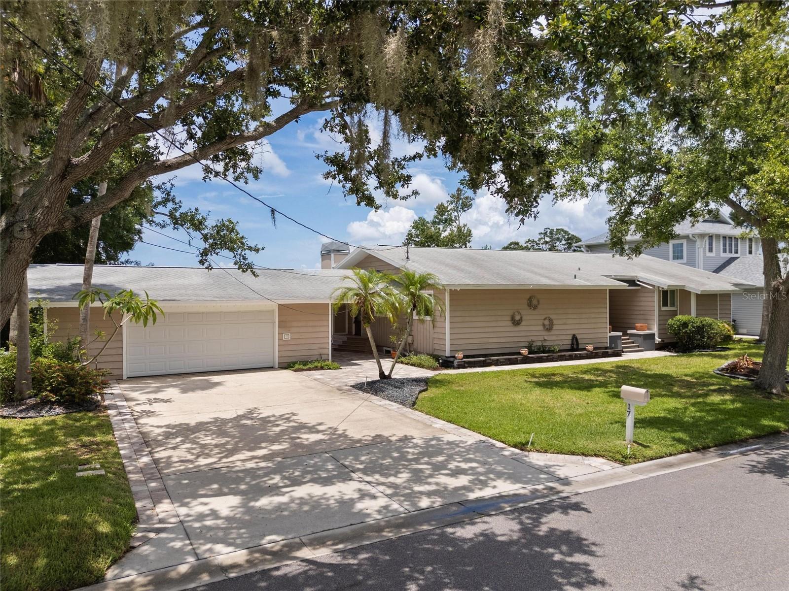 Ever dream of living on Lake Tarpon? Here is your Dream! Beautiful 4 BR home situated on a double lot with 120 feet of frontage on Lake Tarpon, and you can fish right off your own covered boat dock. The home has been updated with granite countertops, wood cabinets, and stainless-steel appliances in the kitchen. Beautiful hardwood floors in the kitchen, dining area, family room, living room, primary bedroom, and plush carpeting in the other 3 bedrooms. Yes, of course, the family room has a fireplace! The oversized garage has room for a workshop and attaches to the home via a covered breezeway. Large windows in the family room give you a spectacular view of the Lake. You do not want to miss this exceptional home on Lake Tarpon.