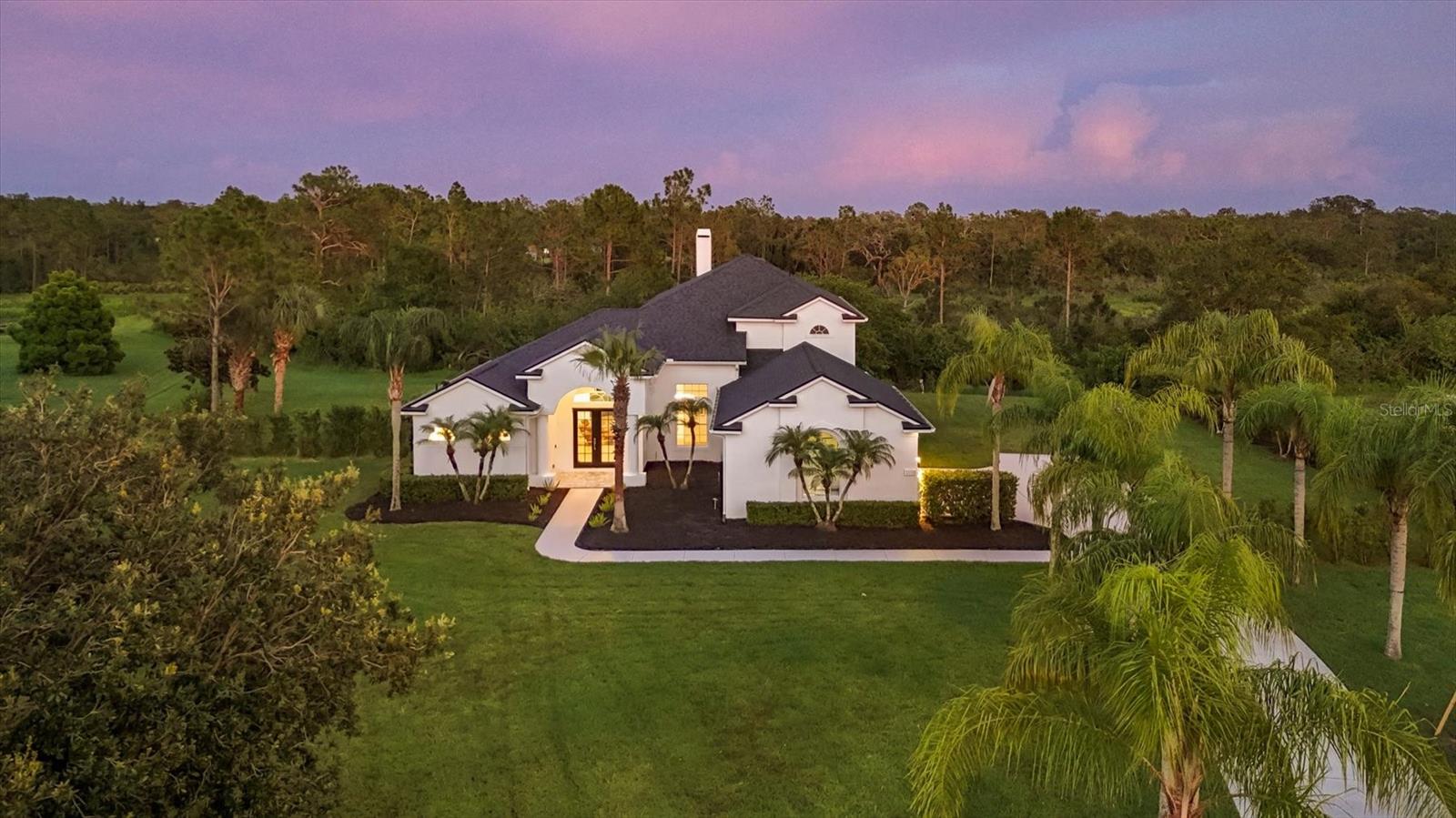 One or more photo(s) has been virtually staged. Welcome to your dream home, perfectly situated on a beautiful 1.34-acre corner lot that backs to protected wetlands, offering unmatched privacy, serene natural views, and room to roam. This spacious, thoughtfully designed home provides the perfect blend of functionality, comfort, and elegance—ideal for modern families, multigenerational living, and those who love to entertain.
Step inside and immediately feel at home. The main floor features a private primary suite with generous space, natural light, and a relaxing layout. Also on the main level, you’ll find a versatile den or home office, a guest bedroom, and a full bath, making it ideal for guests or aging-in-place living.
At the heart of the home is a chef-inspired kitchen designed for both everyday living and special occasions. It features a large cooktop, custom vent hood, double ovens, and an oversized center island that can easily handle holiday baking, casual dining, and everything in between. The open-concept layout connects the kitchen seamlessly to the living and dining spaces, allowing you to cook, host, and relax in one beautiful, flowing area.
Upstairs, you’ll find three spacious bedrooms, another full bathroom, and a large bonus room that’s perfect for a home theater, playroom, game room, or teen retreat. It’s a versatile space that grows with your lifestyle needs.
Step outside to your own private backyard paradise. The newly renovated pool and paver deck are truly the centerpiece for summer and family fun, offering the perfect space to relax, cool off, or entertain guests. There’s plenty of open space for play, gardening, or pets.
Car enthusiasts, hobbyists, and outdoor lovers will appreciate the spacious three-car garage, with ample room to park vehicles, store gear, or even house your boat and jet skis. The electrical panel is prewired with a dedicated junction outlet, allowing you to easily connect the existing generator during storms or power outages—an essential Florida feature.
Recent upgrades include a fully renovated pool and paver deck (2025), new entry pavers (2025), fresh interior paint (2025) and exterior paint (2021), a newer roof (2021), dual AC units (2023) with a transferable 8.5-year warranty on parts and labor, and a beautifully updated kitchen (2021) — all contributing to peace of mind and lasting value."
"Some photos have been virtually staged to help visualize how different furniture -or even your own- might look in the space."