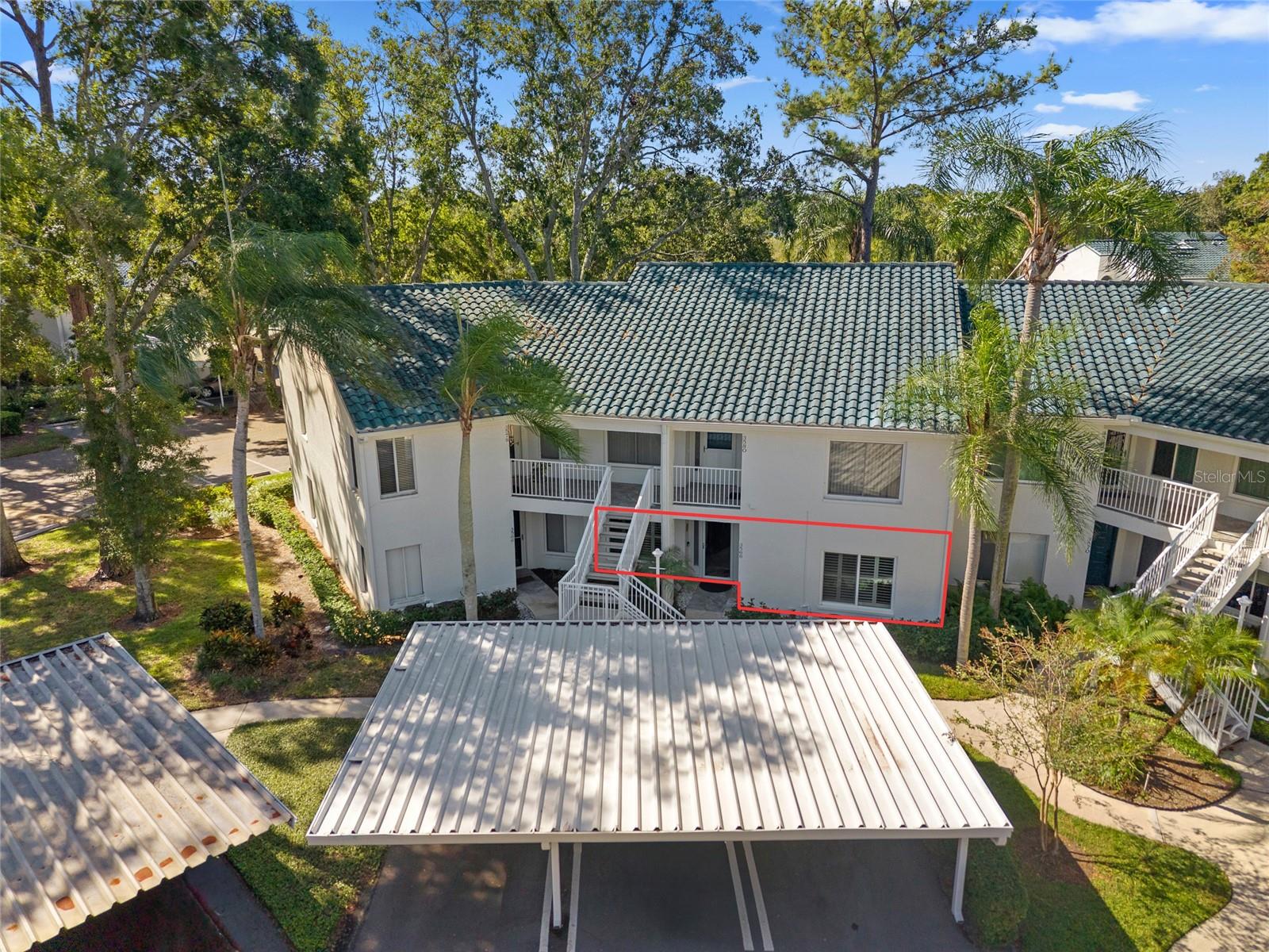 Hard-to-find 1st Floor Unit in the prized Indigo Pond Community - this rare gem is gorgeous and move-in ready, offering the perfect combination of convenience, style and comfort. Nestled back in a quiet neighborhood near John Chestnut Park and Lansbrook golf course, this welcoming home provides a serene retreat while keeping you close to everything in town that you love! Enjoy the ease of first-floor living with hard-to-find backyard privacy, perfect for a small dog - yes, pets are welcome! Step inside to find a meticulously maintained, updated home with modern finishes, stone countertops and a spacious enclosed lanai perfect for relaxing or entertaining family and friends. The main living spaces feature warm wood-look porcelain tile plank flooring with lush carpet in the primary bedroom. Plantation shutters bring timeless style while the newer hurricane windows provide privacy, safety and quiet. The kitchen offers plenty of cabinet and countertop space, matching stainless steel appliances, a roomy breakfast nook and a water purifier at the kitchen sink. You’ll find ample closet space, giving you all the storage you need in a well-designed layout. The best part? The split floor plan and impressive primary bedroom with a walk-in closet and en-suite bathroom. The second bedroom also has an updated guest bathroom nearby, along with a hallway laundry closet including a full size washer and dryer which convey. Have large furniture? The dining and living room can fit it all! The generous spaces can fit large furnishings, and you can extend your living room even more by opening the sliders to the enclosed lanai. Just a swift walk from your back door, cool off at the community pool which is also heated for those cooler winter nights, BBQ at the poolside kitchen or stroll the lush grounds that make this all-ages community so inviting. Important updates include a 2019 AC system, hurricane impact windows installed in 2023 and a tile roof with many years of life left! Outside you have an assigned carport, storage shed and plenty of guest parking. With an unbeatable location near John Chestnut Park, the popular Lansbrook golf course and YMCA, this condo has something for everyone. Non-Flood Zone X and zoned for top-rated Pinellas County schools (including East Lake High) and surrounded by popular restaurants, shopping, golf, movie theater, Mease Countryside hospital, and pristine Gulf Coast beaches — rarely available and ready for you to call home - Call me today to schedule your showing while you can!