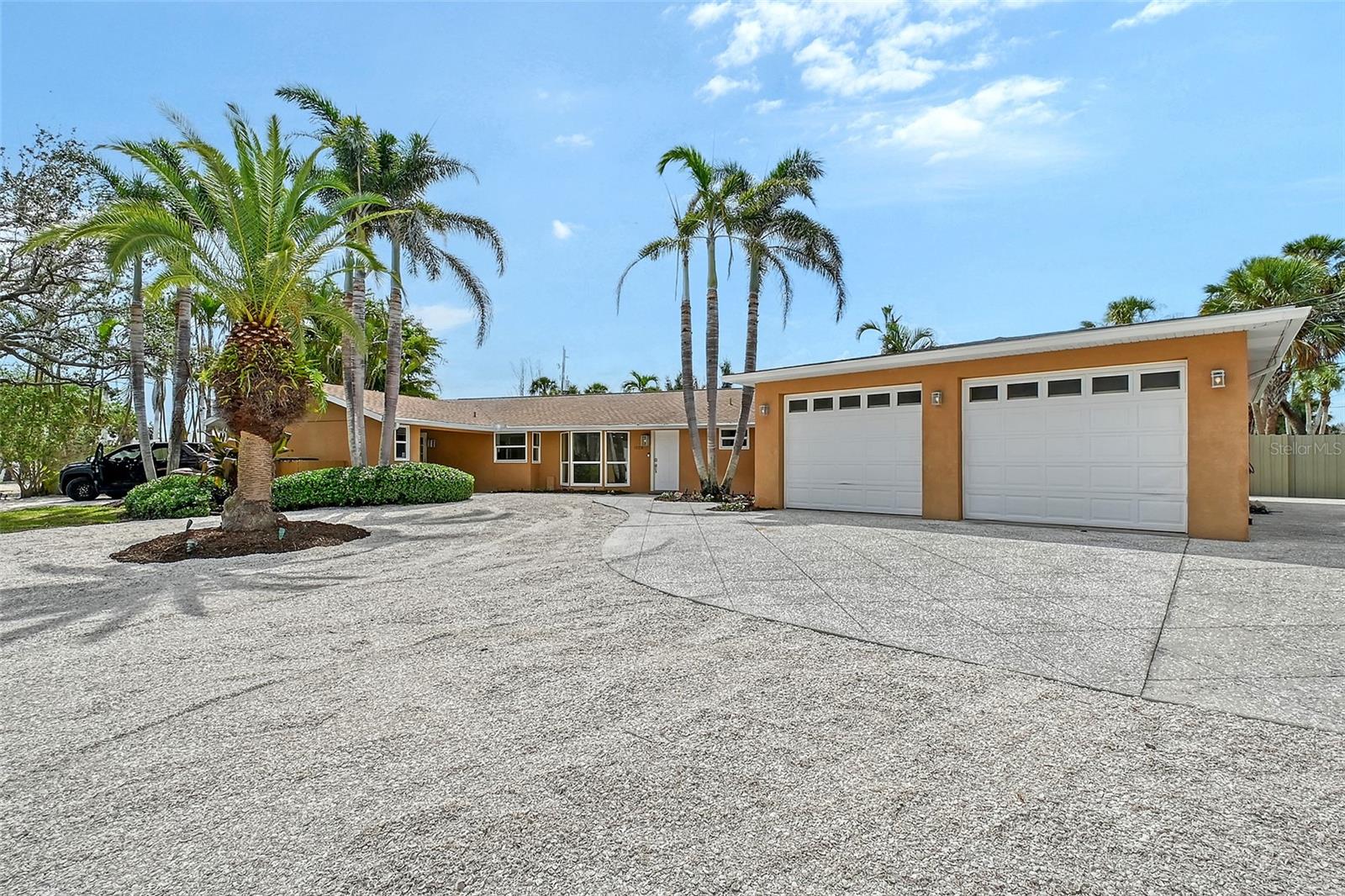 One or more photo(s) has been virtually staged. Gorgeous updated single-story home just a short walk or bike ride away from Crescent Beach / Siesta Key Beach. This stunning move-in-ready home is situated on an expansive 17,000+ sq ft lot with NO HOA. A detached 4 car garage offers plenty of space to bring your RV, boat, and car collection. Interior upgrades include a brand-new kitchen with oversized center island and stainless steel appliances, new 9' luxury vinyl plank flooring, recessed lighting, new interior and fresh interior paint throughout. Bathrooms have been updated with new cabinetry, lighting, and backlit mirrors. Additional features include impact windows and a roof replaced in 2018. The detached garage is nearly 1,000 sq ft with three roll-up doors, elevated ceilings, a bathroom, EV charger, 50-amp RV service, RV cleanout connection, and dedicated parking pad for RV or boat. Connected to county water with a private well for irrigation. Plenty of space for a pool, ADU, or future home expansion. Located on a quiet street live your dream of morning beach walks and be minutes to Sarasota’s shopping, dining, and cultural amenities. See Matterport Virtual Tour in 1st link.