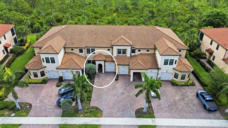 Welcome home to this beautifully appointed first-floor condominium in the highly desirable, amenity-rich community of Sarasota National. Offering 2 bedrooms and 2 full bathrooms, this maintenance-free residence features 9-foot ceilings with crown molding and a bright, open layout designed for comfortable living and entertaining.

The kitchen is the heart of the home, complete with a spacious island with seating, quartz countertops, stainless steel appliances, and a generous pantry. Thoughtful upgrades can be found throughout, including plantation shutters, pendant lighting, an oversized sink, and ceiling fans in every room that add both style and comfort. The custom walk-in closet in the primary suite provides excellent organization, while the ensuite bath features dual sinks and a clean, functional design.

Both the primary and second bedrooms feature luxury vinyl plank flooring, adding durability and a modern, cohesive look throughout the home.

The built-in entertainment center with an electric fireplace adds a warm and inviting focal point, while triple sliders open to a large screened lanai with sunshades, offering peaceful preserve views and the perfect setting to relax, unwind, and enjoy the sunrise. Additional highlights include a separate laundry room with extra storage, a decorative front screen door with Ring doorbell, hurricane impact windows, smart home features for energy efficiency, and a garage with additional parking.

Residents of Sarasota National enjoy an impressive lineup of amenities, including a 7,000 square foot fitness center, full service spa, resort style pool and spa, tiki bar, coffee lounge, tennis, pickleball, bocce, dog park, and more. As an Audubon International Certified Sanctuary, the community offers a unique opportunity to experience Florida’s natural beauty and wildlife.

The HOA covers water, sewer, cable, pest control, exterior maintenance, irrigation, and full access to amenities. Ideally located just minutes from Venice beaches, shopping, dining, Historic Venice Island, CoolToday Park, and Downtown Wellen Park, this home offers the perfect blend of comfort, convenience, and lifestyle. This is your opportunity to find your paradise in Sarasota National.