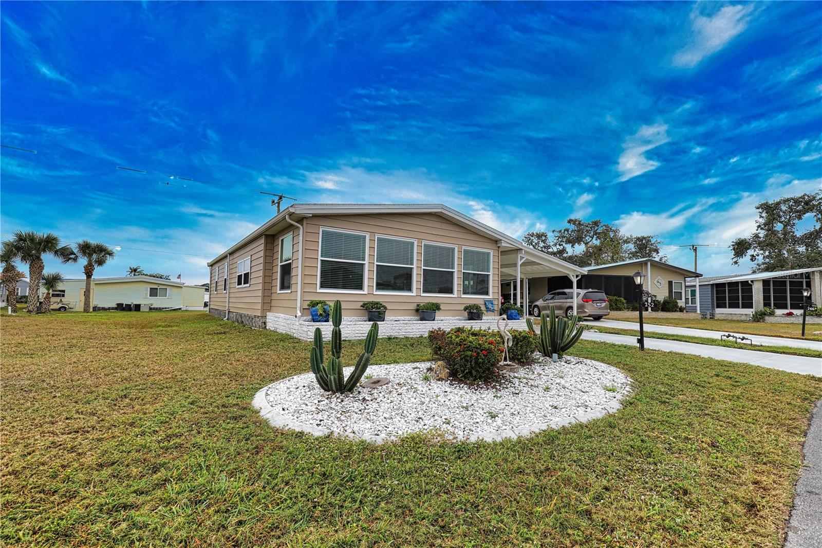 Embrace the opportunity to own a slice of paradise in this enchanting home nestled on a tranquil street within a vibrant 55+ community. The inviting open layout seamlessly blends the kitchen, dining room, and living room, creating the perfect atmosphere for entertaining family and friends. Step into the stunning, brand-new oversized Florida Room, adorned with hurricane windows that welcome an abundance of natural light, creating an idyllic space perfect for relaxation or a productive home office. Retreat to the spacious primary bedroom, complete with both a walk-in closet and a wall closet, providing you with ample storage. The ensuite bathroom offers a wealth of storage solutions and features a luxurious walk-in shower. Thoughtfully designed, the hallway showcases additional built-in storage that maximizes space. Your guests will feel right at home in the cozy guest bedroom, featuring a walk-in closet and charming built-in shelving. The guest bathroom is well-appointed with a delightful tub and shower combination, ensuring comfort and convenience. Throughout the home, you'll find delightful skylights that illuminate every corner, enhancing the inviting ambiance. The property boasts an epoxy-coated driveway and newer carport straps, ensuring both style and durability. Revel in the airy allure of vaulted ceilings that elevate the living experience. Recent upgrades include a brand-new roof installed in 2023 and a hot water heater from around 2020, offering peace of mind for years to come. This home is being offered partially furnished, inviting you to step inside and make it your own haven of comfort and charm.
La Casa boasts 974 homes nestled among a variety of native trees with spacious common grounds surrounding our eight lakes. Our lots average a generous 60' by 80'. The ultimate lifestyle on Florida’s Gulf Coast is located between Sarasota and Fort Myers and is a boater's dream with access to the Gulf of Mexico. It is convenient for shopping, sightseeing, golfing, fishing, and boating, as well as all the culture and elegance the Southwest Florida area is noted for. Residents and visitors enjoy the warmth of Southwest Florida winters in a relaxed and unhurried environment far removed from the hustle of Florida’s east coast. You’ll be surrounded by mature lush landscaping which demonstrates the utmost level of care our property receives from residents and management. La Casa may have the best pools in the area. Our crown jewel is an extremely large, 40 X 60-foot swimming pool that is kept at a perfect 87 degrees. Our smaller 20 x 40 pool is quietly nestled between the clubhouse and the Activity Building. Both pools have adjacent hot tubs which are ideal for soaking muscles that are tired from golfing or tennis. Wireless Internet (Wi-Fi) is available at the Clubhouse, Activity Building, and Recreation Hall area where these pools & spas are located, so you can catch some rays while you catch up on your email! Sound enticing? La Casa is a friendly, family community. You will be away from the hustle and bustle except when you want to be part of it. Come for a visit to this self-contained oasis and see for yourself why La Casa is the ultimate destination for both snowbirds and year-round residents!