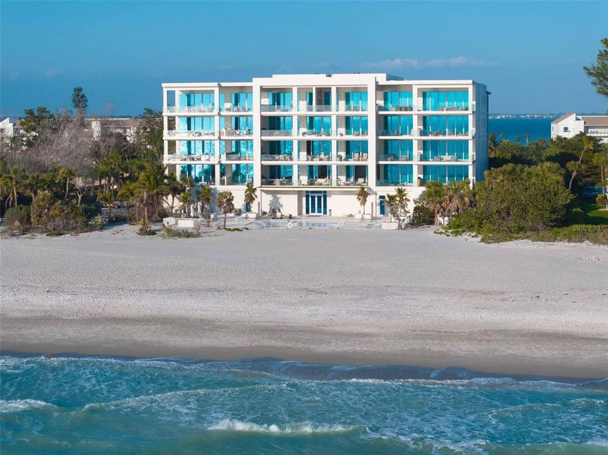 Embrace unparalleled modern elegance and coastal serenity at Infinity on Longboat Key, where refined architecture meets the timeless beauty of the Gulf of Mexico. This exclusive boutique condominium boasts only 11 meticulously designed residences, offering a private and luxurious retreat for those seeking a sophisticated island lifestyle. From your private elevator, enter a spacious foyer that flows into an expansive living area, where floor-to-ceiling glass sliders frame breathtaking Gulf views. Beyond, a large covered balcony with an outdoor kitchen and multiple seating areas beckons, perfect for alfresco dining amid endless ocean vistas. The open-concept kitchen exudes sophistication through its thoughtful design. Custom cabinetry in warm wood tones pairs beautifully with pristine stone countertops and Italian Britannium backsplash. Premium stainless steel appliances, including a gas cooktop and sleek hood, anchor the space. A central island provides both functionality and visual interest, while elegant pendant lighting and expansive Gulf views elevate the aesthetic, creating an inviting culinary environment that seamlessly blends style and practicality. The exquisite primary suite is a haven of calm, with sliders opening to a private balcony where you’ll awaken to the sound of waves and views of turquoise waters lapping sugar-white sands. The spa-inspired primary bath offers a tranquil escape, featuring dual vanities, a water closet, and a spacious walk-in shower. Thoughtfully designed guest suites ensure privacy and comfort. A versatile flex room provides endless possibilities, whether used as a home office, media room, or den. Additional conveniences include a well-equipped laundry room with ample counter space and storage. This condo comes with two private garages that can fit four cars. Resort-style amenities elevate the living experience with a beachfront heated pool, private spa overlooking the beach, large sun deck, beach access, an outdoor entertainment area, clubhouse with catering kitchen, fitness center, and pickleball/tennis courts. Infinity’s prime location on Longboat Key provides effortless access to St. Armands Circle’s world-class shopping and dining, as well as the vibrant cultural offerings of downtown Sarasota. Golf enthusiasts can enjoy nearby championship courses, while boating enthusiasts have easy access to marinas and coastal waterways.
