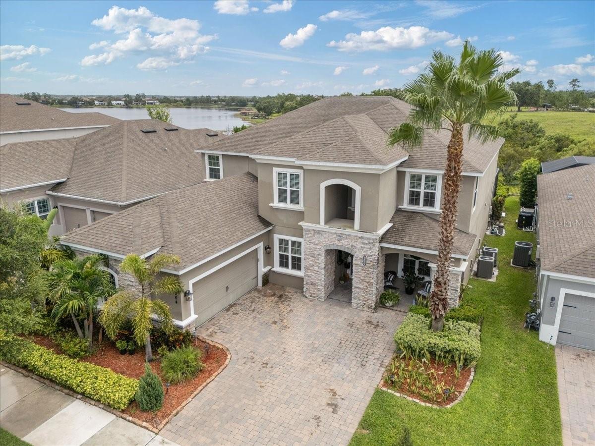 BEAUTIFULLY APPOINTED LAKEVIEW ESTATE HOME! Welcome to this exceptional two-story "Courbet" model located in the highly sought-after Overlook at Hamlin community in Winter Garden. Built in 2017, this expansive residence offers over 4,000 square feet of beautifully designed living space. Featuring four spacious bedrooms, three and a half baths, and two versatile dens—one on each floor—this home is ideal for flexible living, whether you need a home office, media room, or guest accommodations. Additionally, the second floor includes a flex room that can easily function as a fifth bedroom, oversized walk-in closet, playroom, or craft space. Soaring 10- to 12-foot ceilings, tray ceiling details, and abundant natural light contribute to the home’s open and inviting ambiance.
The gourmet kitchen is a chef’s dream, featuring a large eat-in area, luxurious butler's pantry with coffee bar, solid-surface countertops, ENERGY STAR-rated appliances, natural gas cooktop, ample cabinet space, modern decorative range hood and sleek mosaic tile backsplash throughout. The upstairs game room provides the perfect space for entertaining or relaxing, while the main living areas boast elegant and comfortable spaces teaming with natural light. Enjoy outdoor living year-round with a covered patio, a private saltwater pool, and a tranquil backyard with panoramic lake views, ideal for gatherings or quiet evenings.
Overlook at Hamlin is a master-planned, amenity-rich community offering a lifestyle like no other. Residents enjoy access to a clubhouse, resort-style pool, fitness center, BBQ pavilion, fire pit, playgrounds, dog park, fishing pier, and a community boat ramp with dock on the lake. The community is walkable and features bike paths, walking trails, neighborhood sidewalks, a tot lot, and beautifully maintained green spaces.
Zoned for top-rated Independence Elementary, Bridgewater Middle, and Horizon High School, this move-in ready home offers the perfect combination of luxury, flexibility, location, and lifestyle in one of Winter Garden’s most desirable communities. Schedule your private showing today!