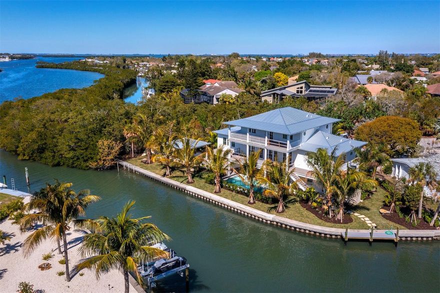 Under Construction. Come experience the epitome of true island living in this exceptional Caribbean Coastal home, currently under construction on Longboat Key! Uniquely positioned on a peninsula at the end of the secluded Longview Drive in the Buttonwood Harbour community, it features 4 bedrooms, 4.5 baths, in 3793 light-filled sq. ft. The home is filled with seaside hues and stunning architectural details in an open, inviting floor plan with a dream chef’s gourmet kitchen. With multiple oversized porches on the front and back, it allows for coastal breezes and water views in all directions for the perfect indoor/outdoor balance. From the moment you arrive at this extraordinary residence, with a breezeway looking out to the pool and an elevator to bring you to every floor, you will notice no detail has been overlooked and be captivated by its high-quality craftsmanship. Spend your days basking in the sunshine from your infinity pool and spa with a sun shelf overlooking 170 feet of canal on Cranes Bayou or head out on your boat kept at your newly constructed dock, for a day of fishing and diving. A screened cook shack surrounded by trees, sits in the secluded side yard for ultimate entertaining. The irrigation is run off a neighborhood Artesian well. A gorgeous stretch of sandy coastline on the Gulf of Mexico is just a short distance away, where nightly sunsets are a must. Make an appointment to see this unique, one-of-a-kind dream property, slated to be complete in the first few months of 2024, and savor the laid-back luxury island lifestyle that Longboat Key is known for. When you are ready for more, the world class shopping and cultural epicenter of St.Armands Circle and Downtown Sarasota are just a short drive over the bridges, bringing you a remarkable quality of life. Call us today for your exclusive and private showing!