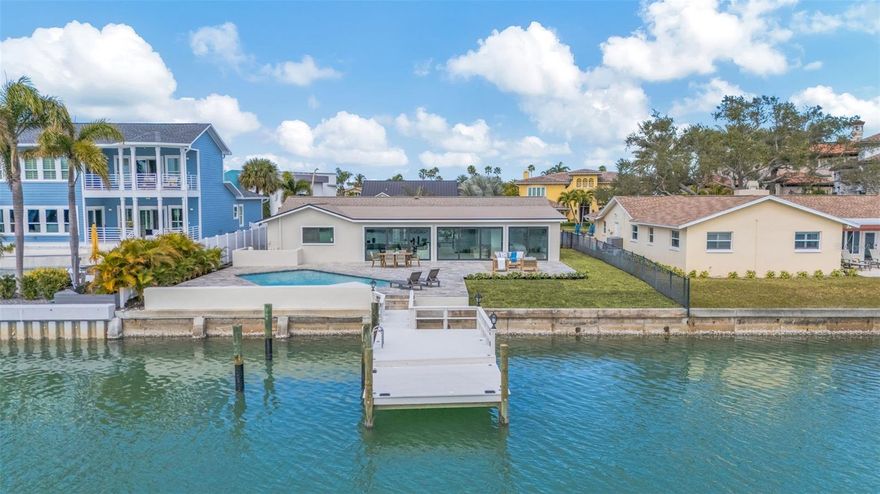 Full custom design and renovation by the Parks property builders. Waterfront home offers timeless mid-century modern architecture. Located in a cul-de-sac on highly desirable neighborhood of Capri Isles. This 3-bedroom to Bath waterfront Home offers timeless architecture. Your boat. Will be in your backyard. Right next to your beautiful pool with views of a wide open water of Capri Isles. Everything in the home is new top to bottom. Dual walk-in closets in your Owner's suite. The en-suite bath has Double shower, Beautiful spa tub, Double sinks vanities. The home features ceramic, light, wood-like tile throughout.  Open water Views all across the  Glass sliders doors at the back of the house. Back yard has large travertine patio with pool and private dock. The kitchen is equipped for the best of the gourmet chefs. Featuring oversized, large center island. Perfect for entertaining. Top-of-the-line, professional-grade appliances. New landscaping. New air conditioning. New pool equipment. New pool. New roof. New water heater. Everything in the home is new. Beautiful and ready for occupancy complete this exceptional coastal property.