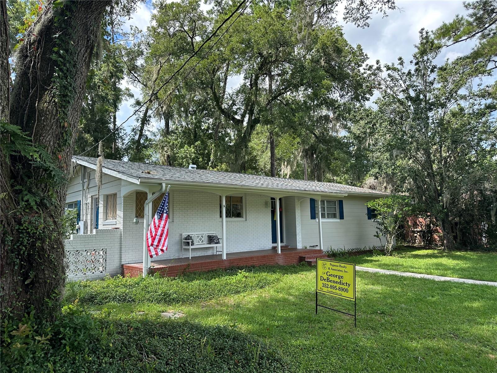 Right across from Fisher Park in highly desirable SE Ocala! This charming 3 bedroom, 2 bathroom block home sits on a spacious corner lot with peaceful views of the park right from the front porch. Enjoy quiet streets lined with mature oaks, all just minutes from Downtown Ocala. Built by Mr. Fisher himself, this home features original hardwood floors throughout, a NEW roof (2019), and a new AC (2022). The unique open floor plan combines the living, dining, and Florida room—something rarely found in homes of this era. Whether you’re a vintage home lover or looking to remodel to your personal taste, this property is full of potential. Don’t miss your chance to experience its charm.