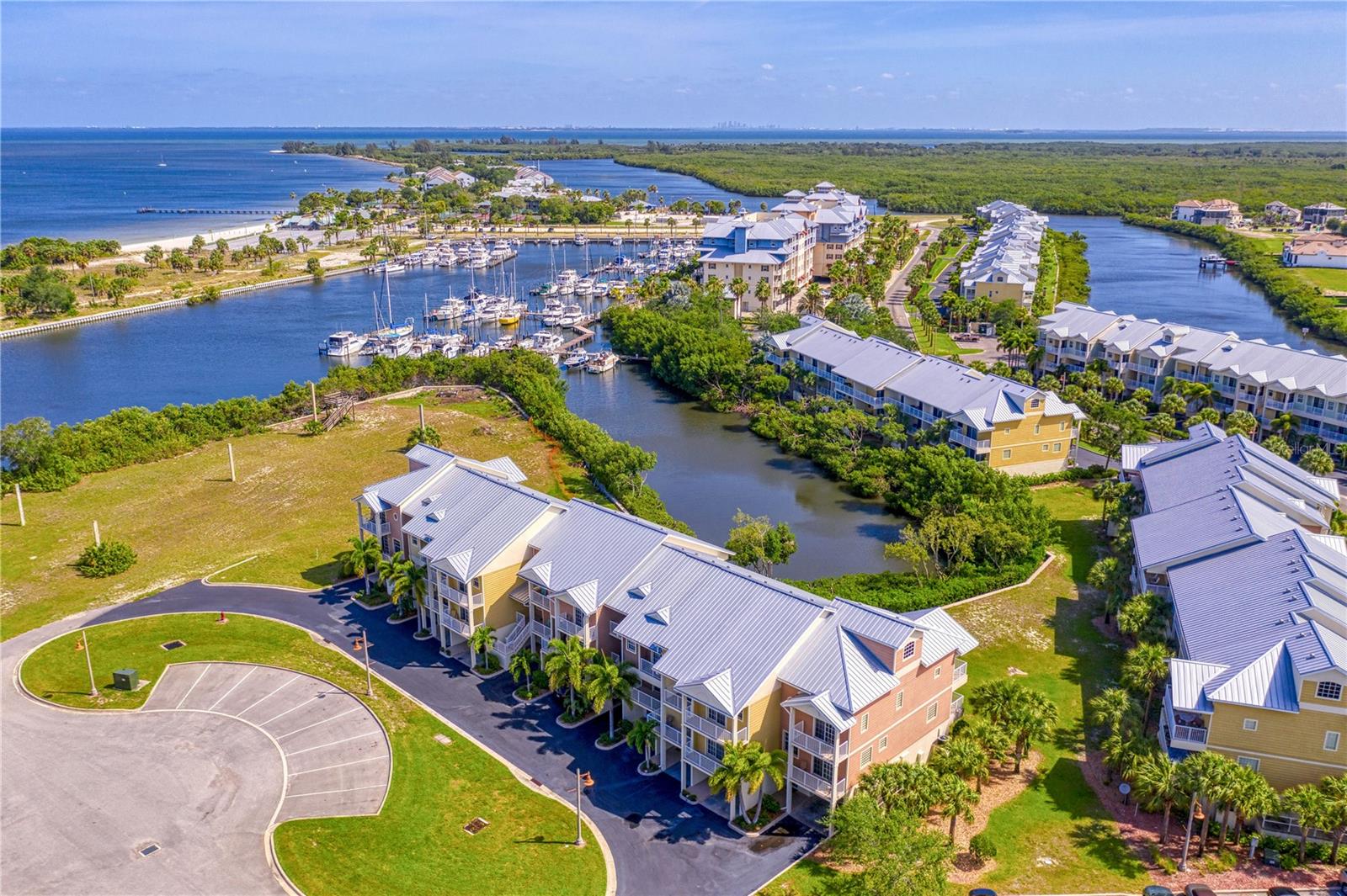 WATERFRONT town home w/ metal roof, concrete construction and 4 spacious terraces to enjoy year round indoor/outdoor living in the seaside village of Little Harbor. For community aerial view, click Tour 2. This destination resort type lifestyle offers an on-site white sand and secluded BEACH, 2 waterfront restaurants/sports/tiki bar, newly constructed fishing pier and private outdoor seating area with a fire feature, heated swimming pool, tennis courts, a pickle ball court, clubhouse with fitness center, 2 deep water marinas, high & dry storage w/ slip availability. BOATERS paradise- direct access to the Bay/Gulf-no lifts or bridges. Freedom Boat Club on-site. Nature enthusiasts use the recently constructed community boat launch for canoeing/kayaking on the RIVER & canals, while enjoying dolphin and manatee sightings. Of course, with the location of this particular town home you never have to leave home to enjoy manatee and dolphin sightings. It is literally Manatee Haven with as many as 10-25 sightings per day as these gentle giants frolic and entertain just feet from your terrace as you watch in wonder and delight! Enjoy an Eco Tour in the afternoon or a Sunset Cruise aboard the Latitudes Pontoon with or without a dining option. Additional water sports include Paddle boards and Jet Ski's available for rent. FISHING mecca with a multitude of fishing charter selections or fish directly off the community Pier. Great primary or secondary home or investment with minimum rentals being daily - perfect for AIRBNB. Highly desirable location to enjoy the breathtaking sunsets. The town home's recent upgrades include luxury vinyl plank on both the stairway as well as the second floor, along with the refrigerator, dishwasher, stackable washer/dryer and A/C being nearly new at less than a year old. This move-in ready home awaits the next fortunate owner with its inviting beach design vibe while providing the ultimate in comfort and relaxation. As a bonus, additional entertaining space provided in garage with dining table, chairs and mounted TV. Convenient location-approximately half hour drive to Tampa, St. Petersburg, and Sarasota. Shopping, hospitals, restaurants, & golf courses all nearby. The taxes include the CDD. Don't miss out on this immaculately kept home - call TODAY to schedule an appointment!
