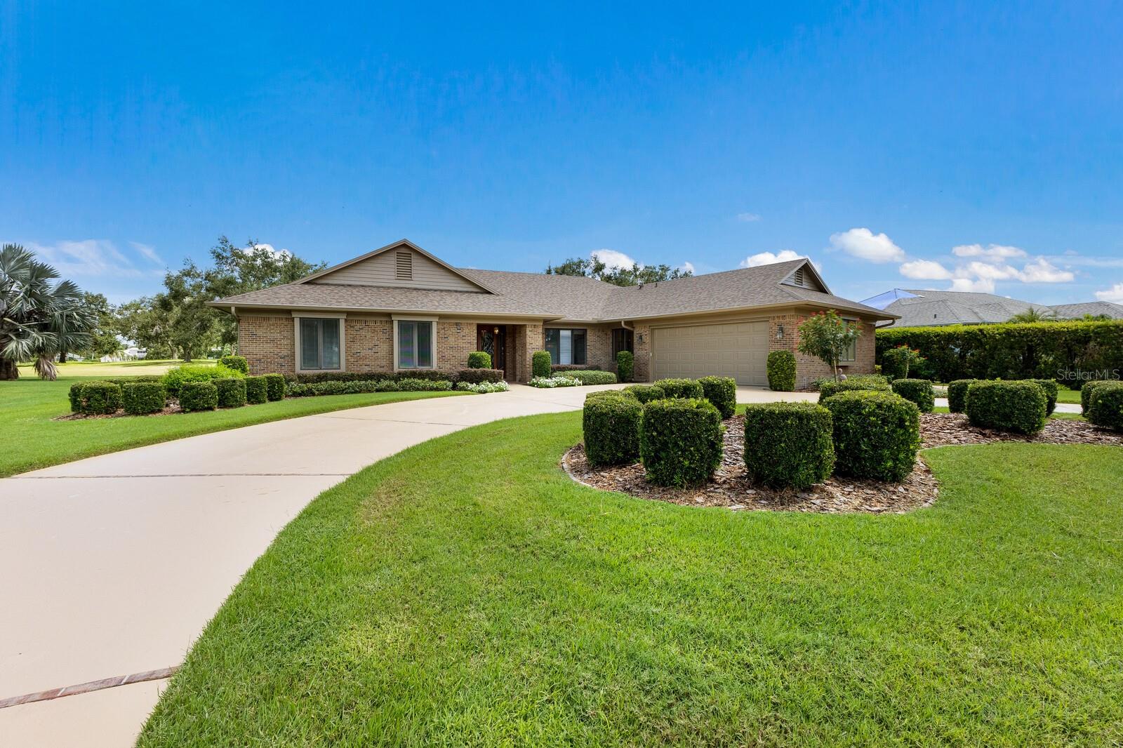 Welcome to River Wilderness, where timeless design meets modern, cozy comfort. This custom brick masonry home, built by the original owners, greets you with a beautiful leaded glass front door and a freshly painted exterior, driveway, and garage floor. Inside, the spacious living and dining areas are filled with natural light from large windows and sliding doors that open to the lanai. The chef’s kitchen features a prep island, breakfast bar, eat-in area, built-in desk, two pantries, and newer stainless appliances with filtered and instant hot water. A large great room with a wood-burning fireplace, custom built-ins, and a wet bar makes entertaining effortless. The split floorplan provides privacy with two guest bedrooms in their own wing—one with a sitting area overlooking the golf course—while the primary suite offers two walk-in closets, a soaking tub, and a seamless walk-in shower. A flexible office/den with a window seat sits just off the primary. Additional features include a spacious laundry room with storage, 2.5-car garage with golf cart entry, two hot water heaters, exquisite crown molding throughout, solid wood doors, Pella windows with built-in blinds and hurricane film, and a brand-new roof (2025). Outdoor living shines with a spacious lanai offering covered seating, a wet bar, and a sparkling heated pool overlooking the 11th tee box of The Club at River Wilderness. The community provides oversized lots, mature landscaping, and conveniences such as 24-hour guard gates, a boat ramp, and bocce courts. Optional memberships at The Club at River Wilderness provides golf, pickleball, tennis, fitness, and dining, with pay-as-you-play options. Conveniently located near the Ft. Hamer Bridge, you’ll enjoy easy access to Bradenton, Lakewood Ranch, Sarasota, and St. Pete, along with nearby shops and dining.