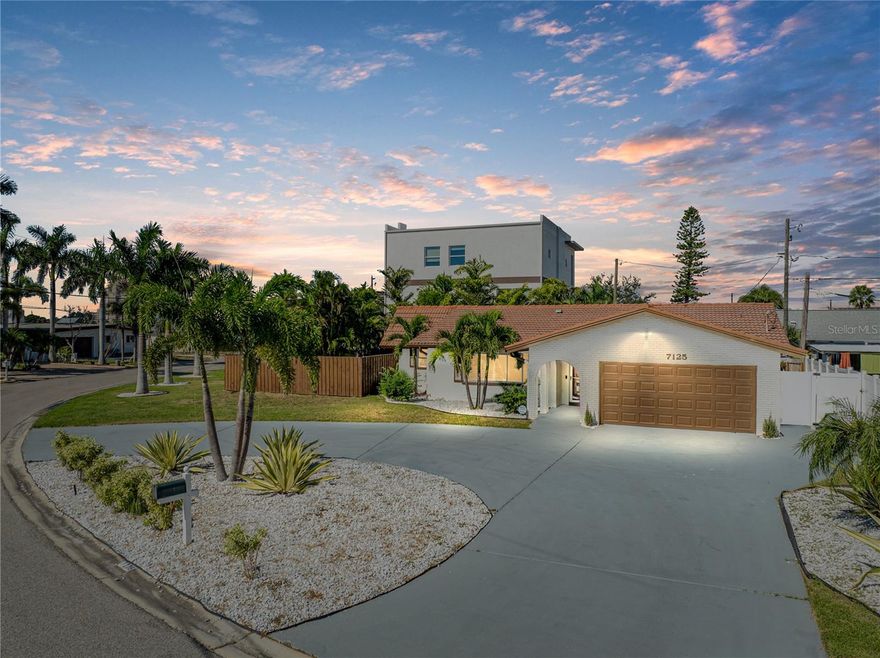 Welcome to your slice of paradise in South Pasadena, where Mediterranean charm and coastal elegance come together just steps from the shimmering waters of Boca Ciega Bay and right around the corner from St. Pete Beach. Nestled on a curved corner lot in one of the city’s most desirable neighborhoods, Pasadena Isle, this two-bedroom, two-bathroom residence captures the essence of Florida living — relaxed, refined, and ready to entertain.  From the moment you arrive, the home’s curb appeal is undeniable. A classic white brick exterior, complemented by a traditional tile roof, sets the tone for timeless architecture. Framed by swaying palm trees and lush landscaping, the circular driveway offers a gracious welcome with ample parking and an easy flow for guests and gatherings.  Step inside to a bright and airy interior where natural light dances across light luxury vinyl plank flooring, creating a fresh and inviting ambiance. The open-concept floor plan is designed for both entertaining and everyday living — a seamless flow from the spacious living area to the beautifully updated kitchen and dining spaces.  The heart of the home is the stunning chef’s kitchen, thoughtfully designed with clean modern lines and upscale finishes. Sleek quartz countertops offer generous prep space, while custom cabinetry provides abundant storage. Stainless steel appliances, a shimmering mosaic tile backsplash, and elegant pendant lighting complete the look, making this kitchen as functional as it is beautiful.  Retreat to the expansive primary suite — a tranquil sanctuary offering comfort and style in equal measure. A large walk-in closet keeps everything organized, while the spa-inspired en suite bathroom boasts designer finishes, a walk-in shower, dual vanities, and refined tile work that invites relaxation after a day by the bay.  The guest bedroom and additional full bath are equally well-appointed, perfect for hosting out-of-town guests or creating a home office or creative space.  Step outside into your private backyard oasis — a thoughtfully designed escape made for unwinding and entertaining under the stars. A bubbling jacuzzi sits beneath a pergola-style partial enclosure, creating a serene hideaway for quiet evenings or lively weekend get-togethers. Gather around the built-in fire pit on cool coastal nights, or enjoy alfresco dining surrounded by the privacy of your fully fenced backyard.  Located just moments from the waterfront, this home offers the best of both worlds — a peaceful residential setting with the vibrant energy of downtown St. Pete just minutes away. Enjoy morning strolls along the bay, bike rides to nearby parks and marinas, and easy access to world-class dining, shopping, arts, and cultural events. * Pool renderings and quote available from Island Way Pools - ask for details if interested (under $57,000)! *