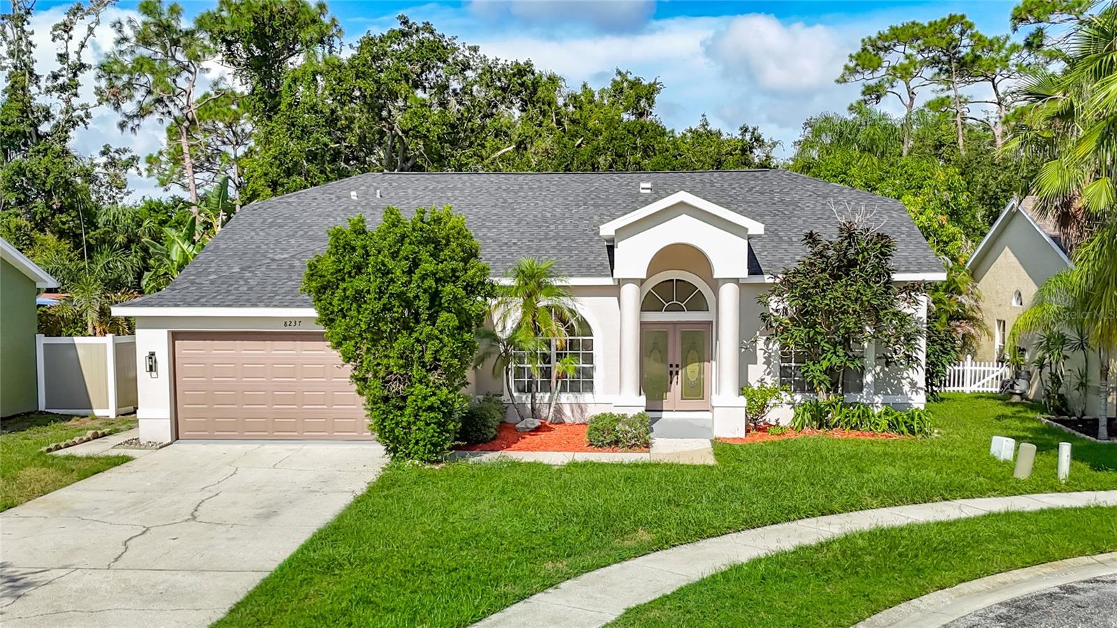 One or more photo(s) has been virtually staged. To help visualize this home’s floor plan and to highlight its potential, virtual furnishings may have been added to photos found in this listing. Discover your dream home at 8237 Setters Point Dr, New Port Richey, FL 34653! This stunning, fully remodeled one-story residence boasts 4 bedrooms and 2 full bathrooms, perfectly situated on a serene cul-de-sac lot backing up to a tranquil wooded conservation area. Step inside to find a thoughtfully designed layout featuring separate dining and living rooms, complemented by an open-concept kitchen and family room ideal for modern living. The home shines with fresh upgrades, including laminate flooring throughout, fresh interior and exterior paint, a new roof, new AC, new water heater, and completely updated bathrooms. The gourmet kitchen is a chef’s delight, equipped with brand-new stainless steel appliances, sleek shaker cabinets, and elegant granite countertops. Outside, enjoy a covered patio overlooking a sparkling inground pool and spa, perfect for relaxing or entertaining while surrounded by peaceful natural views. Located just minutes from vibrant local attractions, you’re within 20 miles of the pristine beaches of Clearwater Beach (18 miles), the family-friendly Starkey Wilderness Park (10 miles), and the charming Tarpon Springs Sponge Docks (8 miles) for dining and cultural experiences. Enjoy shopping and entertainment at the Tampa Premium Outlets (15 miles) or explore the scenic trails at Jay B. Starkey Wilderness Park. This move-in-ready gem combines modern luxury with a prime location, offering the best of Florida’s Gulf Coast lifestyle!