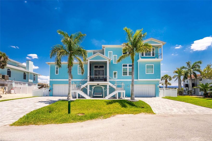 Experience the ultimate waterfront lifestyle in this stunning canal-front estate, offering nearly 9000 total square footage and 100 feet of prime frontage and direct access to the Intracoastal Waterway with no bridges and quick access to Stump Pass and the Gulf. Designed for both luxury and functionality, this 4-bedroom, 3-bath residence delivers exceptional indoor-outdoor living at every turn.
Step outside to your private resort-style oasis featuring a marble pool deck, sparkling pool and spa, a built-in gas fire pit and gas tiki torches, perfect for entertaining under the Florida sky. Multiple expansive lanais on every level, connected by a striking spiral staircase, create seamless spaces to relax and take in the water views. The fully equipped outdoor kitchen includes a grill, sink, ice maker, mini fridge, and ample storage, making it ideal for hosting. Boating enthusiasts will appreciate the 50-foot dock, 10,000 lb. boat lift, and jet ski dock.
Inside, no detail has been overlooked. The home showcases custom wood ceiling details, rich walnut stairs, elegant moldings, and all-wood custom cabinetry throughout. Quartz countertops elevate every space, while built-in features enhance all closets, the great room, and the primary suite. A spacious walk-in pantry adds convenience, and bedrooms 2 and 4 enjoy direct lanai access.
The entire third floor is dedicated to a luxurious primary retreat, complete with a private sitting area, den, lanai, and a custom walk-in closet. The spa-inspired primary bath features split vanities with vessel sinks, jetted spa tub and a walk-through shower for a true retreat experience.
Modern comforts include an elevator servicing all floors, paver driveways, fenced yard, impact-rated PGT windows and sliders, a whole-house generator, propane connections for major systems, a full-home speaker system, alarm system with cameras, mosquito misting system, and irrigation. A 4-car garage with epoxy floors provides ample space for vehicles and storage.
This is a rare opportunity to own a meticulously designed waterfront home that perfectly blends luxury, comfort, and boating convenience.