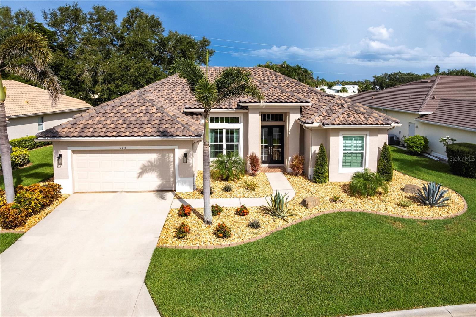 Experience the ultimate Florida lifestyle in the exclusive award winning gated community of Pelican Point Golf and Country Club. Just minutes from the quaint streets of downtown Venice as well as the laid back Venice beaches. This popular Sam Roger's “Lido” floor plan offers 2137 sq. ft. under air with 3 bedrooms and 2 full bathrooms. Enjoy peace of mind with the new tile roof (2025, $49k) and all new PGT impact windows throughout as well as motorized storm roll downs at the front entry and back lanai (2025, $41k). Top of the line HVAC installed in (2022, $12.8k). The interior features soaring ceilings with tray ceilings in the family room and master bedroom, crown molding and beautiful 24 inch tile with 5 inch baseboard recently installed through the entire home. The kitchen features granite countertops and backsplash, stainless steel appliances as well as solid wood cabinets with over and under lighting. The master and guest bathrooms have been tastefully updated. The home offers triple sliders that open fully to the paved and screened lanai. The exterior was just professionally landscaped in November 2024 and features river rock over new contractor grade weed block and drip line irrigation. There is also a pool prep package with electric and water already in place in the event you ever want a pool of your own now, or in the future. The low HOA fees include lawn care, high-speed internet, expanded cable TV, 24/7 gate guard security and a social membership. Golf cart friendly community! Take your golf cart to the included social membership features which include a fitness center, tennis and pickle ball courts, heated pool, full service restaurant and pub as well as a pro-shop. Pelican Point is a 27 hole semi-private championship golf course and a full practice facility. Over $165,000 spent on improvements and upgrades since 2022! Furniture optional. Golf membership is optional and not required. Don’t miss this opportunity, schedule your showing today!