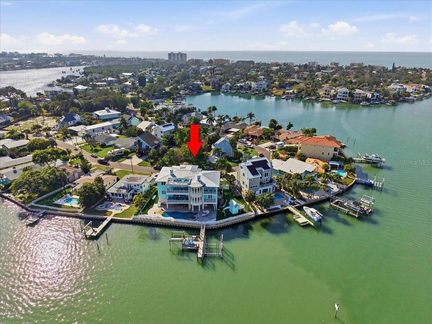Discover unparalleled waterfront living in this magnificent 6-bedroom, 6.5-bath residence, perfectly situated on a rare double waterfront lot in Indian Rocks Beach. Offering approximately 146 feet of water frontage, an extra-large seawall, private dock, and boat lift, this home is a boater’s dream and an entertainer’s paradise.
Step inside to experience seamless open-concept living designed for both grand entertaining and comfortable everyday life. The chef’s gourmet kitchen features a massive island, high-end professional appliances, and a walk-in pantry, creating a space that is as functional as it is stunning. Impact-rated windows and doors, solid block construction, and a metal roof provide peace of mind and enduring quality.
Resort-style amenities await outdoors, including a Freestyle PebbleTec saltwater pool and a fully equipped outdoor kitchen, ideal for alfresco dining and waterfront gatherings. An elevator offers effortless access to all levels, while a whole-house audio system, smart home technology, and generator ensure comfort, convenience, and security.
The primary suite is a true retreat, featuring a fireplace, private sitting area, expansive walk-in closet accented by a Swarovski chandelier, and a spa-inspired en-suite bath with soaking tub, oversized shower, and private balcony. With seven covered balconies, en-suite baths for every bedroom, two laundry rooms, a dedicated office, and a 3+ car garage, every detail has been thoughtfully designed to elevate the waterfront lifestyle.
This extraordinary home offers a rare opportunity to enjoy luxury, space, and waterfront adventure in one of the area’s most desirable beach communities. Schedule your private showing today and experience coastal living at its finest. Buyer to verify all room sizes and dimensions are approximate.