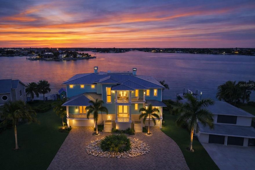 Discover unparalleled waterfront living in this magnificent 6-bedroom, 6.5-bath residence, perfectly situated on a rare double waterfront lot in Indian Rocks Beach. Offering approximately 146 feet of water frontage, an extra-large seawall, private dock, and boat lift, this home is a boater’s dream and an entertainer’s paradise.
Step inside to experience seamless open-concept living designed for both grand entertaining and comfortable everyday life. The chef’s gourmet kitchen features a massive island, high-end professional appliances, and a walk-in pantry, creating a space that is as functional as it is stunning. Impact-rated windows and doors, solid block construction, and a metal roof provide peace of mind and enduring quality.
Resort-style amenities await outdoors, including a Freestyle PebbleTec saltwater pool and a fully equipped outdoor kitchen, ideal for alfresco dining and waterfront gatherings. An elevator offers effortless access to all levels, while a whole-house audio system, smart home technology, and generator ensure comfort, convenience, and security.
The primary suite is a true retreat, featuring a fireplace, private sitting area, expansive walk-in closet accented by a Swarovski chandelier, and a spa-inspired en-suite bath with soaking tub, oversized shower, and private balcony. With seven covered balconies, en-suite baths for every bedroom, two laundry rooms, a dedicated office, and a 3+ car garage, every detail has been thoughtfully designed to elevate the waterfront lifestyle.
This extraordinary home offers a rare opportunity to enjoy luxury, space, and waterfront adventure in one of the area’s most desirable beach communities. Schedule your private showing today and experience coastal living at its finest. Buyer to verify all room sizes and dimensions are approximate.