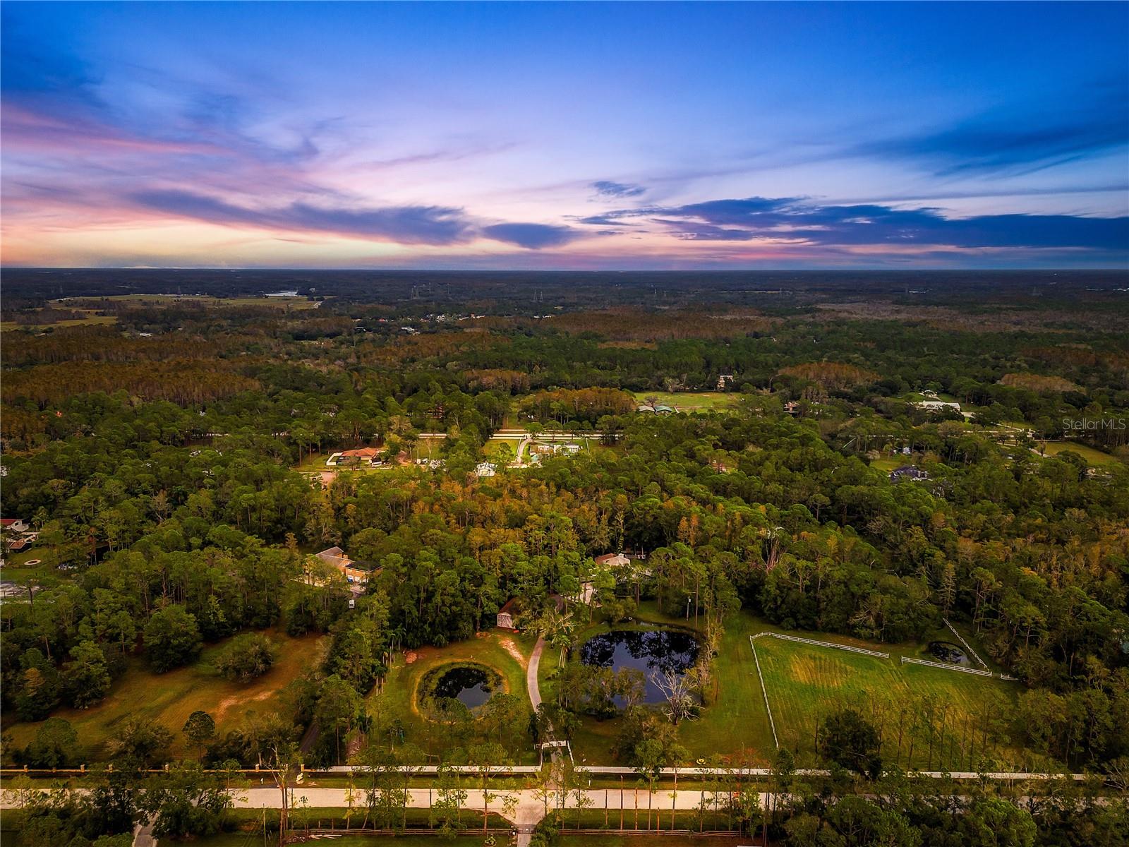 RARE FIND. 10-Acre EQUESTRIAN PROPERTY in North Pinellas. NO HOA or DEED RESTRICTIONS. Option to subdivide. Horse & Livestock welcome. Option to APPLY FOR AG CREDIT (via cattle or honey bees). HOME will either need to be completely RENOVATED or TORN DOWN AND BUILD NEW. Pool and Outdoor kitchen should be able to stay in place. PRIVATE HORSE TRAILS FOR KEYSTONE RANCHETTES RESIDENTS ONLY VIA RANCH RD. TO BROOKER CREEK EQUESTRIAN TRACK. *** BONUS FEATURE *** Easement at the back of the main property which provides easy access to the private horse trails. You DO NOT NEED to trailer your horses to take them on morning or sunset rides. Just ride out of your barn outback down the easement to the private entry. FULLY STOCKED POND with Channel Catfish, Tilapia, Largemouth Bass and THOUSANDS of Mosiquito Minnows (cost-effective & environmentally friedly way to control mosquitoes in ponds), several drainpipes throughout the property, STALL BARN with tack room, storage, water, fans, and lighting, DETACHED BUILDING (900 sq ft. with 2021 HVAC system), (2) pastures, (1) paddock, (3) deep water wells, R.V. junction box with 30-amp, 50-amp, and 120-amps, (2) SEPTIC TANKS (2020), 500-gallon propane tank. POOL: oversized NEW screened pool cage with picture frame and no-see-um feature, extra wide and deep pool, NEW no-slip tiled decking for entire lanai, surround sound, (2) shower heads. OUTDOOR KITCHEN: commercial grade, detailed stonework, leathered granite counters, ample electric outlets, lighting, surround sound, TV hook-ups, gas range, grill, griddle, dual refrigerators, sink, storage, and (3) vented hoods. If you decide to renovate the home there are already ALL NEW WINDOWS, FIREPLACE, GUN SAFE ROOM, and WHOLE HOME water purification system (ultraviolet & reverse osmosis). Build your FAMILY & HORSE COMPOUND that will provide a lifetime of memories for generations! ULTIMATE LOCATION — Enjoy the convenience of being just minutes from the nearest Publix shopping plaza, only 8 miles from beautiful Sunset Beach, and approximately 20 miles from Tampa International Airport. Golf enthusiasts will love being just minutes from the Tarpon Springs Golf Course. Hiking enthusiasts will enjoy over 5 miles of trails in Brooker Creek Preserve. But that’s only the beginning. This area offers an exceptional equestrian lifestyle at home, paired with easy access to Florida’s top-rated beaches, premier golf courses, renowned restaurants, leading hospitals, vibrant theaters, scenic parks, and world-class fishing — all within arm’s reach.
