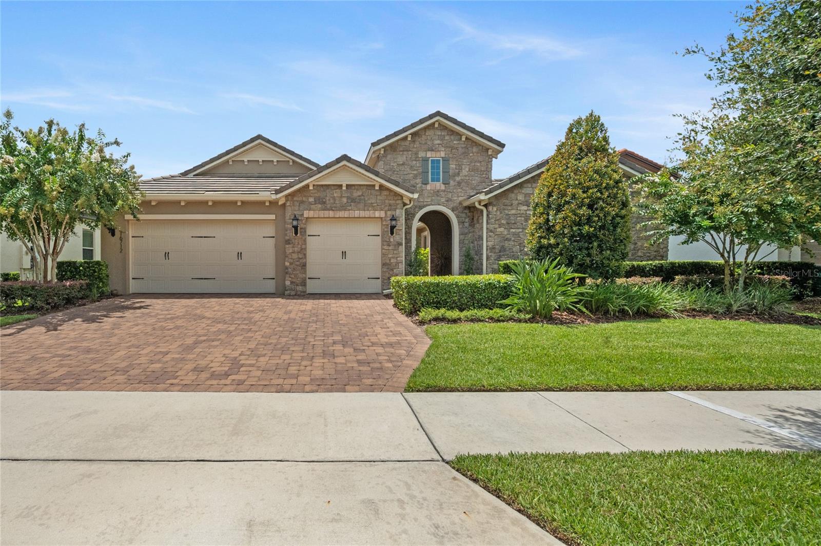 Incredible MOVE-IN READY home in one of the most sought-after communities in one of the most desirable cities around Orlando! If you are looking for your dream home with easy access to downtown Orlando, Disney, and the charm of downtown Winter Garden, come see this 4 bedroom / 3.5 bathroom, 2,934 sq ft, 3-car garage, single story Waterside community home! Built in 2019, this home has been lovingly cared for, meticulously maintained, and generously upgraded by the original (and only) owners. ***
Copy and paste this link into your browser's address bar for the VIDEO Walk-through TOUR: tourbuzz.net/2342755?idx=1
(If the website on which you are viewing this property does not show the link or the 3D floor plan, contact your Realtor for those today!) ***
No detail was overlooked in the design of this home, from the 300+ sq ft paver breezeway and courtyard, to the elegant practicality of the open-concept living areas (living room, dining room, kitchen, dinette with bar), to the SECOND PRIMARY SUITE, to the plentiful windows allowing abundant natural light and exception views to the BACKYARD OASIS. Upon entering the home, note the 8' doors and 9.5' ceilings, rounded archways and crown molding, accent beams in the dining room tray ceiling, custom lighting, and consistent use of beautiful and functional Silestone and luxury vinyl plank flooring. The kitchen features all stainless steel appliances, GAS STOVE, and HUGE SERVICE ISLAND with breakfast bar, and TWO WALK-IN PANTRIES. The large primary suite (over 530 sq ft) features a bathroom with separate vanities, large step-down shower with bench, garden tub, and privacy toilet, with an 80+ sq ft walk-in closet and direct access to the lanai. ***
Upgrades include LUXURY VINYL PLANKING added to all common/wet areas in 2021 (bedrooms remain carpeted), an additional 16'x16' PAVER PATIO with PERGOLA (to match the existing 14'x18.5' paver patio, featuring an INCLUDED custom, hand-made dining table with seating for 12 and outdoor cabinetry with fridge/freezer), TANKLESS WATER HEATER, additional bar cabinetry, engineered wood lanai ceiling, "mudroom" bench and shelving, landscaping, courtyard drip irrigation, new paint, draperies, and more! Owners are also including the LG washer and dryer and courtyard furnishings in the sale of this property. ***
This home is designed to impress with phenomenal entertainment capability yet with privacy for your family members and guests (a double-split bedroom layout)! ***
The Waterside community features a modern fitness center, play and swim lane pool with lake view, clubhouse, park and playground.