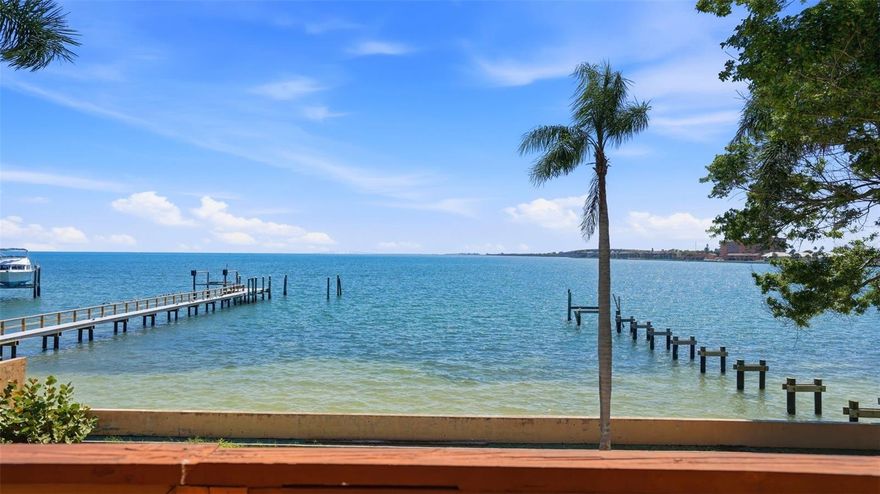 This is a rare opportunity to secure true open-water frontage at the southern tip of St. Petersburg, where wide, unobstructed views of Tampa Bay and the Sunshine Skyway Bridge come together to create an irreplaceable setting. This stretch of Tampa Bay offers a true open-water environment, with broad views, constant movement, and a direct connection to the surrounding ecosystem. Dolphins and manatees are frequently seen, and the shoreline supports a diverse mix of coastal birdlife, creating a setting that feels both active and serene. Positioned at the end of a quiet street, the property offers a level of privacy that is increasingly difficult to find, with approximately 100 feet of waterfront and a lot that lends itself equally well to a major renovation, new construction, or the creation of a massive estate through combination with the neighboring property.
The existing home is both charming and particularly unique. The entryway features a hand-carved wooden pediment with a dual-peacock motif above the front door, reflecting the craftsmanship carried throughout the property. Inside, that same attention to detail continues. An exposed beam is proudly supported by phenomenal hand-carved corbels featuring classical faces, while an incredibly detailed, open-carved wooden transom bridges the upper walkway. Authentic Saltillo tile floors, a majestic heavy-timber newel post, and a custom sunburst-patterned wood railing on the primary suite’s private waterfront balcony give the home a distinctive architectural character rarely found today.
While the 1983 home is a diamond in the rough, these bespoke elements, combined with the home’s spacious vaulted interiors, create a compelling foundation for a visionary renovation. A new owner can salvage, preserve, and elevate these irreplaceable artisan features, or choose to clear the site and build a brand-new architectural masterpiece to fully take advantage of this rare and beautiful location. The lot features a non-functional pool, and the dock is waiting for the new owner to rebuild and customize it to their needs, offering a true blank slate to design your ultimate outdoor waterfront lifestyle.
OPPORTUNITY FOR A GRAND ESTATE: When combined with the neighboring property at 6755 30th St. S (MLS# TB8489791), this becomes the foundation for a one-of-a-kind, magnificent waterfront estate—a footprint and opportunity that is virtually impossible to replicate.
Compared to properties further west in Pinellas Point, this location has some distinct advantages. Just moments away you have direct access to I-275 North and South, meaning that the vibrancy of downtown St. Petersburg is only minutes away. Likewise, you're just blocks away from the Pinellas Bayway, which connects you directly to Tierra Verde, Fort De Soto, and the Gulf beaches. Opportunities like this—a property that provides both supreme convenience and serene open-water living—are increasingly limited.