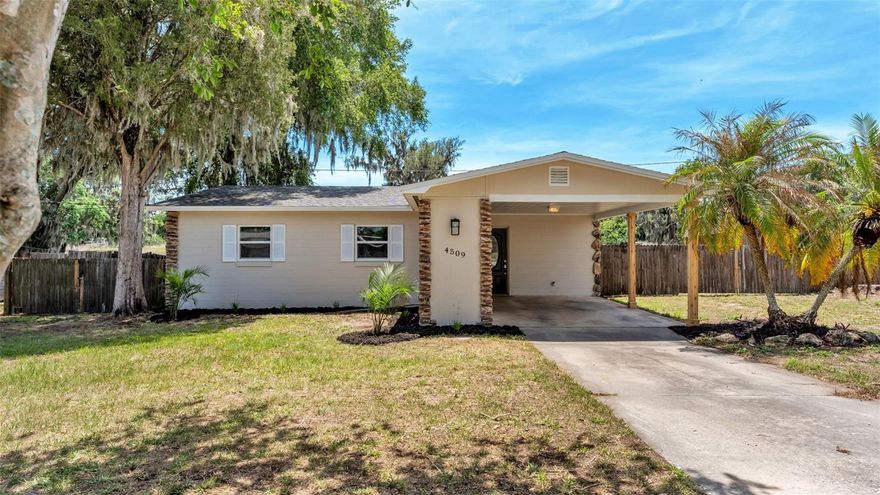 This beautifully updated South Lakeland home offers the perfect blend of modern improvements, functional outdoor space, and peaceful surroundings. Nestled on a spacious lot with open views behind the property, this 3-bedroom, 1-bath residence has been thoughtfully refreshed throughout and is move-in ready. From the moment you arrive, the fresh exterior paint, updated landscaping, covered carport, and mature oak trees create inviting curb appeal with a charming country feel while still being close to everything South Lakeland has to offer. Inside, the bright and functional layout features a welcoming living area that flows seamlessly into the dining space and updated kitchen. The kitchen showcases granite countertops, freshly painted cabinetry, stainless steel appliances, updated fixtures, and ample storage space. Neutral finishes, updated lighting, fresh paint, and durable tile flooring throughout the main living areas create a clean and modern feel, while the bedrooms feature brand-new luxury vinyl plank flooring for added warmth and comfort. The bathroom has been tastefully updated with a modern vanity, upgraded fixtures, and beautifully tiled tub/shower combination with natural light streaming through the window. Major improvements throughout the home include a new roof, new windows, all new outlets and switches including GFCI upgrades, and updated fixtures throughout for added peace of mind. One of the standout features of this property is the oversized screened lanai overlooking the backyard and neighboring open pasture views, creating a peaceful setting for relaxing or entertaining year-round. The backyard offers plenty of room for pets, gardening, storage, or future outdoor additions, and the double gate provides convenient access for trailers, boats, or recreational vehicles. The detached shed is a huge bonus, offering electrical service along with a 40-amp RV plug-in, making it ideal for hobby space, workshop use, storage, or RV setup. Additional features include an AC system that appears to be from around 2019, a 2010 water heater, septic system, covered parking, and mature trees that provide shade and privacy. Conveniently located near 540A, Bartow Highway, and US-98 South, this home offers quick access to the Polk Parkway for an easy commute to Tampa or Orlando while still enjoying the quieter feel of South Lakeland living. Schedule your private showing today.