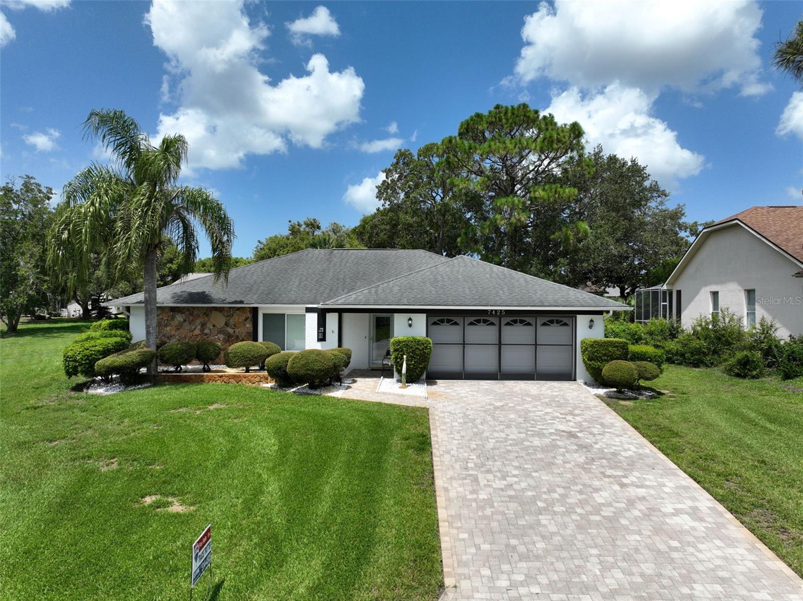 Don't miss this lovingly maintained home in The Heather! Walk into the great room with cathedral ceilings, laminate flooring, large windows, opens to formal dining room, kitchen features plenty of cabinets, pantry, SS appliances, breakfast bar. Opposite the kitchen is a family room or another dining room. Primary bedroom is a generous size, walk in closet, ceiling fan, ensuite primary bathroom features walk in shower. Second bedroom is on the opposite side of the home with berber carpet, ceiling fan and large closet. Hall bath has a tub/shower combo. Inside laundry room with a utility tub. Tranquil lanai has tile flooring and glass windows. Well for the watering the grass/sprinkler system big money saver. Large oversized lot, two car garage, garage door opener, work bench. Permits show AC replaced in 2021, Roof in 2009. The Heather is deed restricted located close to shopping, restaurants, Oak Hill Hospital, Weeki Wachee River, Bayport Park/boat ramp, Rogers Park, easy commute to Tampa or Clearwater.