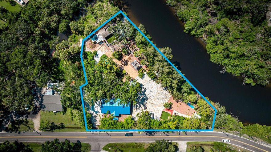 A rare Tampa waterfront investment with 258 ft of private shoreline and proven returns that outperform the stock market. This income-producing short-term rental averages 10.3% annual gross ROI, with total effective returns often reaching 20–33% when factoring appreciation, tax benefits, and leverage—far beyond typical equities. Zoned RSC-6, the property allows multiple dwellings on large lots, accessory structures, and additional units, giving investors the freedom to expand—think tiny homes, cabins, glamping sites, studio suites, or a waterfront event lawn (verify specifics with county). The 1.16-acre estate already operates as a high-performing STR with two mid-century homes, bonus spaces, and room to sleep 30. Guests love the curated amenities: swim spa, hot tub, mini golf, kayaks, paddle boat, fire pit, outdoor shower, yard games, creekside bar, and private boat launch. With strong weekend bookings and untapped weekday potential, this turnkey, fully furnished property offers immediate cash flow and significant upside. Waterfront, revenue, land, zoning flexibility—opportunities like this almost never hit the market. Investor packet available.