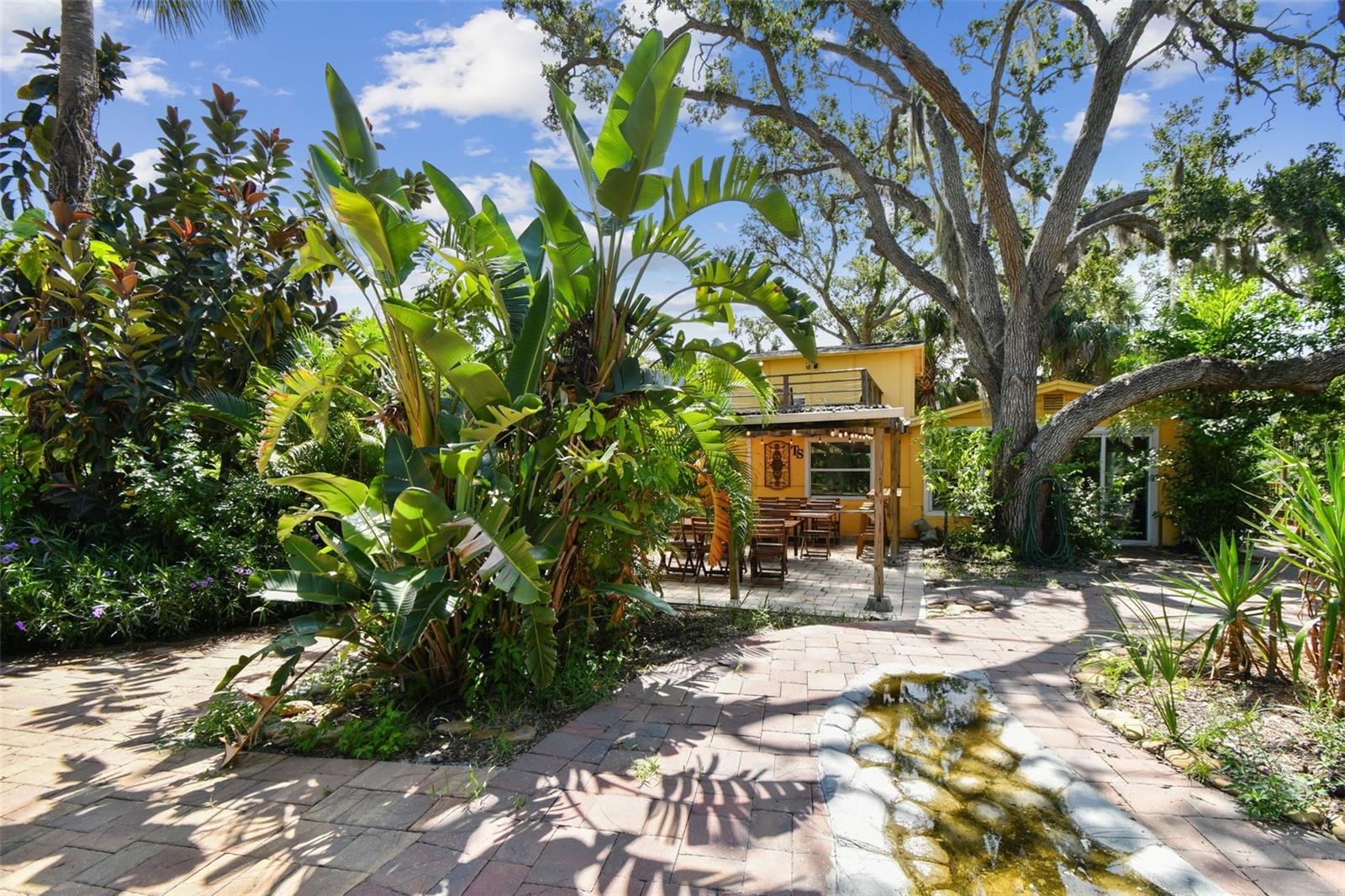 Tucked along the winding waters of Rocky Creek, this hidden 1.16-acre waterfront retreat is just 15 minutes from TPA. Once a cherished family escape, this lush estate has evolved into a sought-after destination for events, gatherings, celebrations and creative getaways. It features two charming mid-century homes—a 1954 single-family and a 1959 duplex—plus bonus units and space to sleep 30 or host many more. Guests are drawn to its unique amenities: a swim spa, hot tub, mini golf, creekside bar, paddleboat, kayaks, canoes, fire pit, outdoor shower, yard games, boat launch, wedding ceremony space and more. With abundant parking and four total parcels, there’s exciting potential for expansion—think glamping, tiny homes or a dedicated event pavilion. Booked primarily on weekends, the estate leaves weekday income virtually untapped. Offered turnkey and fully furnished, it includes existing branding, social presence and future bookings. Whether you continue the legacy or create your vision, this is a rare opportunity with immediate income and limitless growth potential. Investor packet available upon request.