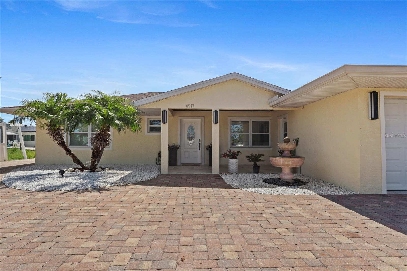 A TRULY WATER LOVER'S PARADISE !!! What a location! what a view! a unique spot of the Bay to watch your Sunsets! Easy access to the Bay from this canal-front home just one house in!. This is a complete newly remodeled 3/3 with a 2 car garage Bay front home!. Great 2 "in suite" bedrooms + a single full bathroom. Everything in this house is been completely remodeled from floors to ceiling. The house features a New 3.5 Ton A/C unit, 1.5 Ton A/C unit in enclosed Lanai, New 24x24 Porcelain tile floors, New modern square baseboards, 8.2'' Ceiling, New Gen Samsung SS Appliances, New Samsung Washer & Dryer, New lightning, New garage door motor, New garage epoxy floor, New exterior double impact windows, New main door, New bathrooms, New kitchen with 42" cabinets, 8 years old Roof, 8 years old Sea Wall, reinforced structure beams, double insulation and double 3/4'' panels in enclosed lanai roof, this was built for a future Sun Deck. Lots of details to be described herein. NO HOA, NO CCD Tax ! Don't lose the opportunity to schedule a showing and learn more about it for yourself!
