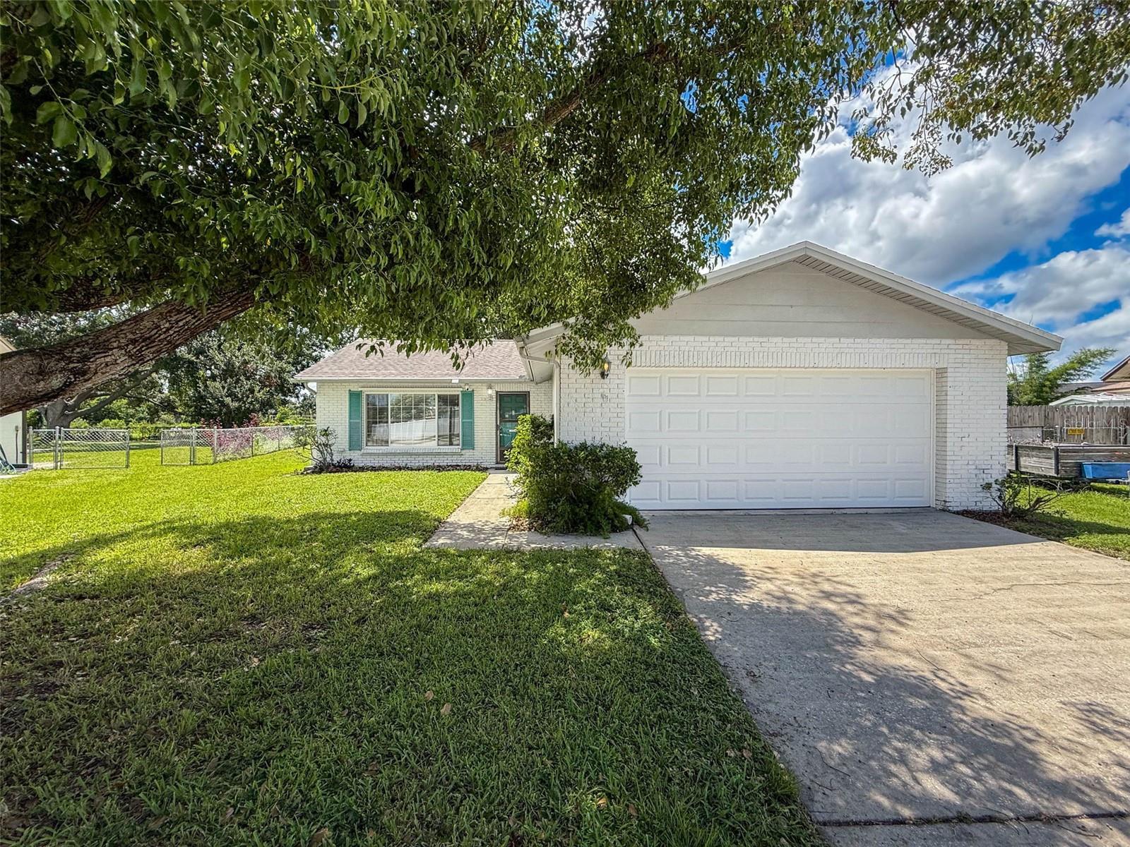 Welcome to this beautifully updated 2 bedroom 2 bath, 2 car garage home. Wonderful location with easy access to Pinellas County & all the great amenities in the Trinity area. A Rated School zone too! Bright & airy open floor plan with high ceilings! Updated kitchen features new cabinets, granite countertops, stainless appliances and room for a table too. The kitchen flows into the dining area & the family room, ideal for hosting gatherings and entertaining. The spacious primary bedroom showcases a renovated en-suite bath and walk in closet. The Guest bath has also been renovated. The fully fenced back yard is HUGE! Updates include garage door w/opener (2024), wood look luxury vinyl plank flooring (2020), interior paint (2020), roof (2018), AC (2021) and updated windows too! Flood insurance is just $535 per year! Just a short distance from vibrant downtown New Port Richey and Starkey Ranch, both offering shopping, festivals, breweries, restaurants & entertainment. Great price for a great location!