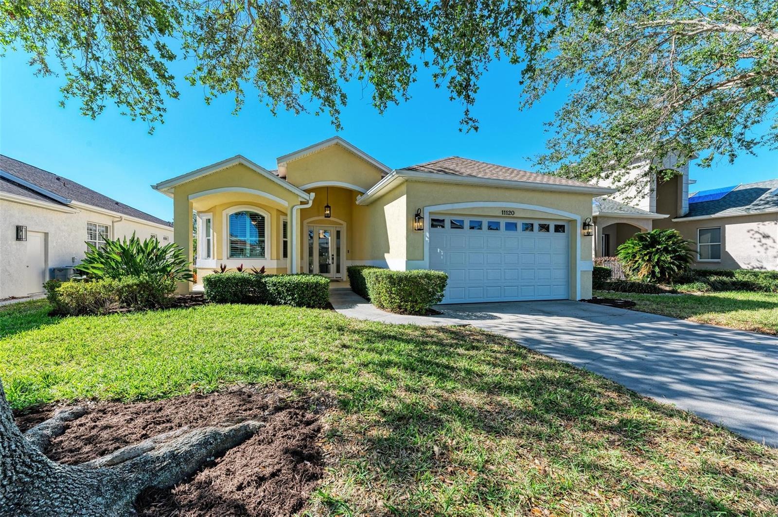 Welcome to 11120 Sanctuary Drive - a Truly, Elegant and Impeccably Maintained Perico Isle Waterfront Home, located just minutes from West Bradenton and Anna Maria Island. A lovely covered front porch and sophisticated foyer greet you upon arrival. The home features an open floor plan with vaulted ceilings, tasteful, fresh paint throughout and a recently remodeled kitchen with quartz countertops and all new appliances. The entire home was replumbed in April of 2024 and the kitchen features a reverse osmosis system, new impact windows and doors added in 2023, a new garage door, the roof was replaced in 2020, and the AC in 2024. New, Stylish ceiling fans and light fixtures complete this perfect picture. A large 22X9 enclosed lanai provides additional living space and is not included in the square footage. The open living area overlooks a paver patio with planting areas and the community lake. The expansive primary bedroom has a large walk in closet and bath with a dual sink vanity, glass stall shower & separate soaking tub. Two more bedrooms, one currently used as an office, another full bath and utility room complete this lovely home. No stone has been left unturned and all has been maintained with consideration and pride of ownership. The community offers a clubhouse, large pool, fitness center & tennis court. Perfect for permanent residence or second home. Walk out your door to Perico and Neal Preserves connecting to 650+ acres of Robinson Preserve w/miles of hiking & biking trails & kayaking thru the coastal waterways. A short 2 miles to the white sandy beaches & turquoise waters of Anna Maria Island.