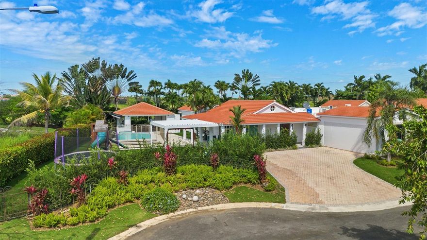 Welcome to luxury living in Sabanera Dorado! Nestled in a prime location just minutes from the De Diego Expressway in Dorado, this stunning 5-bedroom, 5.5-bathroom home offers unparalleled convenience and comfort. Spanning 4,000 sq. ft. on a generous 1,060 sq. mt. lot, this meticulously remodeled residence boasts cathedral ceilings, formal dining, a spacious family room, and a pantry for your culinary delights.

Enjoy the serenity of your own oasis with a private terrace, pool, and views of the lake from the gazebo. The property features top-of-the-line appliances, a wine fridge, and an alarm system for added security. Hurricane shutters, security cameras, and a water cistern ensure peace of mind during any weather event.

Sabanera Dorado offers more than just a home; it provides a lifestyle. Residents have access to great amenities including tennis, soccer, basketball, and Pilates, all within the community. Take advantage of the nearby trails for walking, jogging, or biking, and indulge in daily necessities and treats at Cafe de la Pergola.

Additionally, families will appreciate the inside TASIS Dorado, an esteemed college-preparatory day school with a focus on language mastery and educational excellence. Don't miss your chance to own this corner lot gem in a tranquil cul-de-sac. Experience luxury living at its finest in Sabanera Dorado. Schedule your viewing today! Bedroom Closet Type: Walk-in Closet (Primary Bedroom).