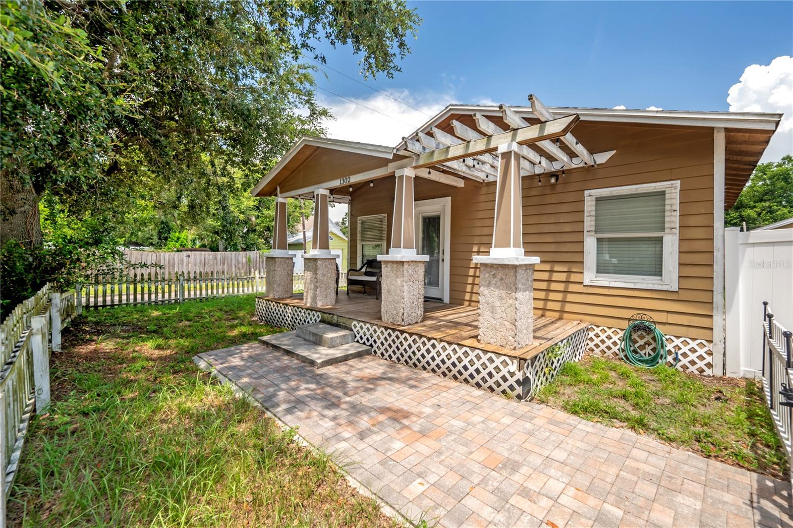Available now, this charming Seminole Heights bungalow offers 2 bedrooms and 2 bathrooms with an open floor plan and vaulted ceilings. The family and dining room combination flows seamlessly into the kitchen, which features stainless steel appliances and granite countertops. Wood laminate flooring runs throughout the main living areas, while the master bedroom is carpeted and includes an en-suite bathroom with a walk-in tiled shower. The private, fenced backyard provides ample space for relaxing or entertaining and includes a detached garage perfect for additional storage. Located on a quiet street with extra parking and friendly neighbors, this home is in a prime location just minutes from Seminole Heights shops, restaurants, breweries, Armature Works, ZooTampa, Downtown Tampa, Hyde Park, and Tampa International Airport.