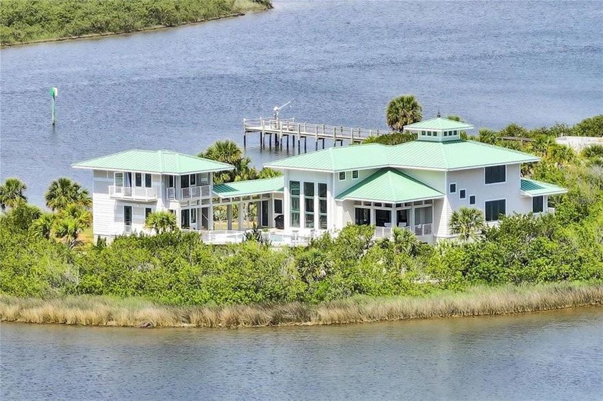 Discover an extraordinary lifestyle in this magnificent estate, inspired by the legendary architect Frank Lloyd Wright and built in 2016. Spanning over 7,600 square feet, this architectural gem is nestled on 2.45 acres at the tip of Cedar Island, presenting an impressive 850 feet of water frontage along the Intracoastal Waterway. Experience unparalleled quality in construction, enhanced by breathtaking water views and refreshing ocean breezes that fill the air. Step inside to find a bright and airy open floor plan adorned with exquisite stone flooring, complemented by an elevator that connects all three levels. Each room offers stunning vistas of the surrounding waters, creating a serene ambiance throughout. The chef's kitchen is a culinary dream, featuring top-of-the-line appliances and a striking granite island, perfect for entertaining. The main living area flows seamlessly to a beautiful outdoor space that includes a spa and pool, complete with swim spa jets for ultimate relaxation. Two elegantly appointed guest suites provide a private retreat, ensuring comfort for family and friends. On the first floor, indulge in a state-of-the-art theater room equipped with a 120-inch screen, alongside approximately 2,200 square feet dedicated to recreation and office space. The property boasts a covered dock with boat lift, perfect for aquatic adventures. Additionally, the expansive 1,100 square foot three-bay garage offers ample room for your prized possessions. This exquisite paradise is conveniently located just 1,500 feet from the golden beaches of the Atlantic Ocean, presenting the perfect blend of luxury, privacy, and natural beauty. Experience the ultimate in coastal living!