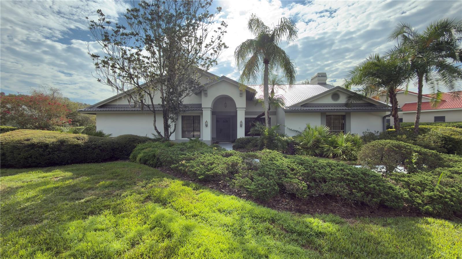 Welcome to 5040 Pinelake Road, a beautifully maintained single-story pool home nestled on nearly half an acre on the golf course in Wesley Chapel’s sought-after Fairway Village. This spacious 3-bedroom, 2.5-bath residence offers 2,866 square feet of open living space with mixed cathedral & vaulted ceilings throughout the home, abundant natural light, and a flexible layout ideal for both entertaining and everyday comfort. The formal living and dining areas flow seamlessly into a cozy family room with a fireplace, while the expansive kitchen provides ample room for culinary creativity and future upgrades. The oversized primary suite features a walk-in closet and a spa-style bath with dual vanities, soaking tub, and separate walk-in shower. Step outside to your private enclosed air-conditioned lanai with glass doors leading out to the sparkling screened pool and spa, surrounded by mature landscaping and peaceful privacy perfect for relaxing or hosting guests. Additional bedrooms and a bonus space that can be used for a home office, gym, or media room. Located in the world-class Saddlebrook Resort, residents enjoy access to luxury amenities including two Arnold Palmer-designed golf courses, 15 tennis courts, a full-service spa, fitness center, and the iconic 500,000-gallon Super pool. Whether you're unwinding with resort-style leisure or exploring nearby shopping, dining, and top-rated schools, this home offers a rare blend of tranquility, convenience, and elevated living in one of Pasco County’s most desirable communities.