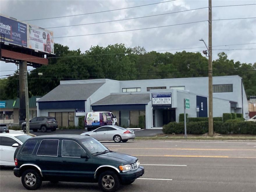 Fantastic opportunity to own a building on the main artery into Dunedin, State Road 580. The property is in a growing commercial area between US Highway 19 and Belcher Road in Clearwater.  Annual Average Daily traffic count of over 44,000 vehicles, this location has the traffic volume needed to drive business.  This 6,000+ square foot 2-story office building has 5 large executive offices (4 of which have their own private bathrooms), visitor waiting room, 1 visitor bathroom, 1 staff bathroom, receptionist office, 2 large conference rooms and 2 medium sized ones, 6 staff offices, a library, computer room, dumbwaiter, a large kitchen/breakroom, and a mail room.  It would be excellent location for a law firm, accountants, chiropractors, or other professional or service business use.   Currently leasing out on short term leases, portions of the building to multiple tenants which offer additional monthly income for a new owner.  Property is located on a busy corner with fantastic visibility, and large pylon sign, and abundant building signage.  Certain furnishing and paintings are available for purchase separately.