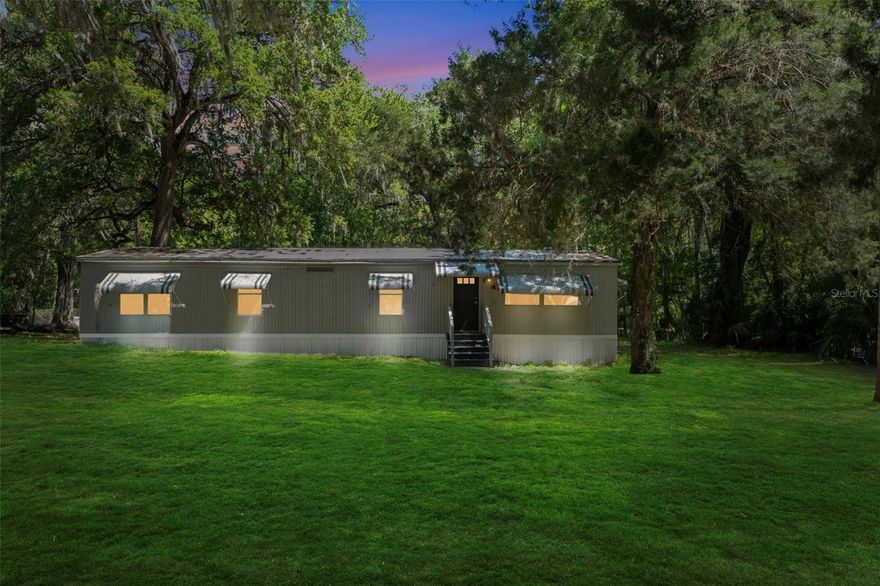 Welcome to peaceful Florida living! This beautifully renovated 3-bedroom, 2-bath home offers the perfect blend of privacy, nature, and convenience. Nestled on a spacious lot, the property features a serene canal on one side, with a wooded backdrop creating a quiet, natural setting. Inside, you’ll find a fresh renovation finished in February 2026, including fresh drywall with knockdown texture, stylishly tiled bathrooms, and a stunning kitchen with granite countertops and a large matching island—perfect for entertaining or everyday living. City water adds convenience and peace of mind. The expansive backyard offers endless possibilities—ideal for fencing in for pets, creating a play area, or simply enjoying the outdoors. Located in a quiet, established neighborhood with easy access to The Villages, I-75, and the Florida Turnpike, this home combines tranquility with accessibility. This move-in-ready home is an incredible value—don’t miss your opportunity to make it yours!