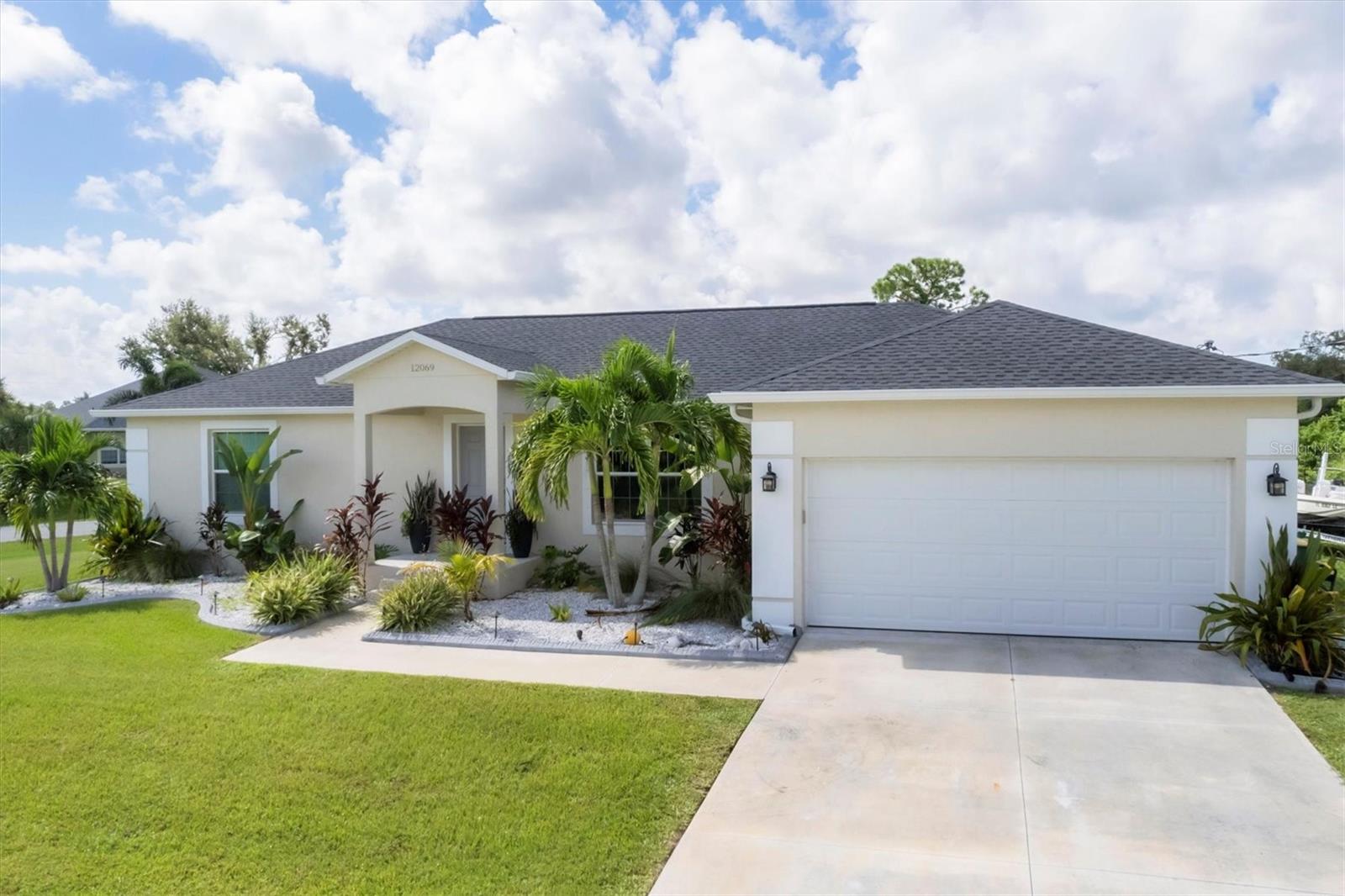Tucked away on a peaceful corner lot in Port Charlotte, 12069 Helicon Ave offers that “this is it” feeling from the moment you step inside. With 1,598 square feet of thoughtfully laid-out space, this 3-bedroom, 2-bath home has the kind of charm and comfort that invites you to stay awhile—and stay for good.
The open floor plan brings everyone together, with elegant tile flooring that flows throughout the main living areas. At the heart of the home is the kitchen—featuring granite countertops, white cabinetry, and a full suite of stainless steel appliances. Whether you’re cooking weeknight dinners or hosting weekend brunch, this space makes it easy to enjoy every moment.
The owner’s suite is designed with comfort in mind, offering a large walk-in closet and a private bathroom with a walk-in shower. The split-bedroom layout gives everyone their own space, with two additional bedrooms and a second full bath featuring another walk-in shower.
Step out to the screened lanai, where your mornings begin with coffee surrounded by tropical blooms—hibiscus, night-blooming jasmine, and vibrant orchids—creating your own garden escape. The oversized corner lot gives you extra outdoor space, and with plenty of room to add a pool, the backyard could easily transform into your favorite place to unwind or entertain.
This home is located in an X flood zone, which means no flood insurance is required—just one more thing to love about the property. And with schools, shopping, and dining options just minutes away, daily life here is both easy and enjoyable. When you’re ready for sand between your toes, the beautiful beaches of Southwest Florida are a quick 13-minute drive.
12069 Helicon Ave isn’t just a house—it’s the kind of home that fits you perfectly for the long haul. The kind you walk into and instantly imagine building a lifetime of memories in.