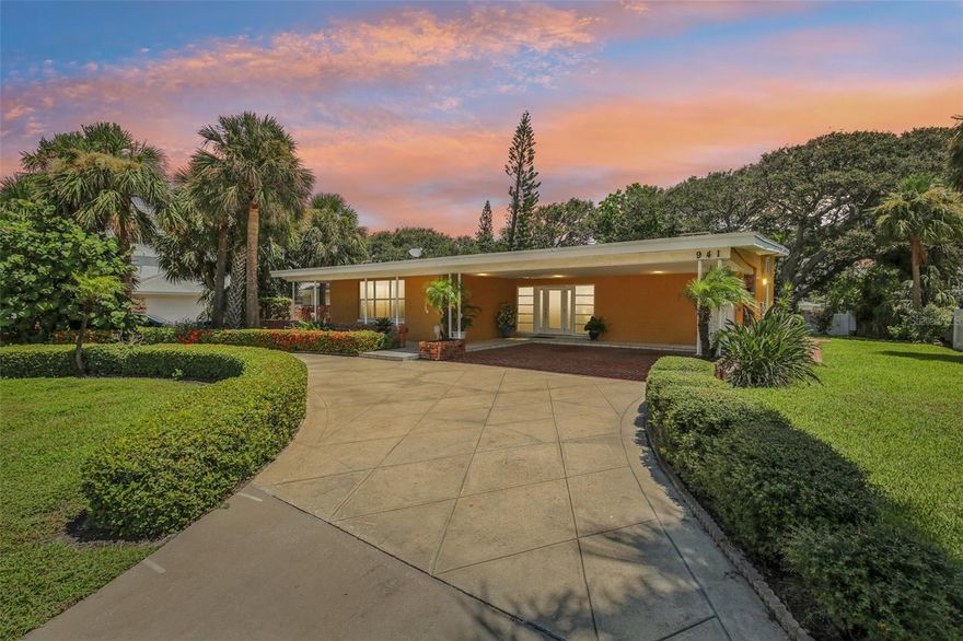 One or more photo(s) has been virtually staged. DIRECT VIEWS of Belleair Beach can be enjoyed from the spacious front porch, and the large formal living room.  This beautifully maintained and updated home offers a large formal living room with large windows with direct views of the beach, a spacious kitchen with wood cabinetry, closet pantry, and new stainless-steel appliances (2025).  The kitchen opens to a large great room with a wood burning fireplace.  You will also find 3 spacious bedrooms with walk-in closets (2 bedrooms with ensuite bathrooms), 4 bathrooms, and a bonus room with an ensuite bathroom.  You will find high ceilings, and a lot of windows flooding the great room with a lot of natural sunlight, and a granite fireplace to cozy up to during cooler days and romantic nights.  The bathrooms have wood cabinetry, and the hall bathroom has a skylight window and a granite countertop.  The 3rd bedroom can be used as an in-law suite with 2 private entrances.  The bonus room is versatile, offering 2 entrances and can be used as an office, a part of the possible in-law suite and more.  There is new carpet in the bedrooms, new laminate flooring, new baseboards, new washer and dryer (2025) and new electrical wiring (2025).  The HVAC was replaced in 2020.  There is space for outdoor entertainment with the front porch and the patio in the side yard.  There is a circular driveway for additional off-street parking, 2 car carport, and generous storage.  This home is on a partially fenced, landscaped ¼ lot across the street from Belleair Beach.  You and your family will have fun living in the Belleair Beach community offering private beach access, a private boat launch, a Clubhouse on the intracoastal waterway, a park, tennis courts, pickle ball courts, and there is a public boat ramp accessible from the Belleair Causeway Bridge.  Living here you will be minutes from Indian Rocks Beach, Clearwater Beach, Belleair Bluffs, shopping, restaurants, medical facilities, entertainment, golfing and more.  Live in your coastal dream home today.