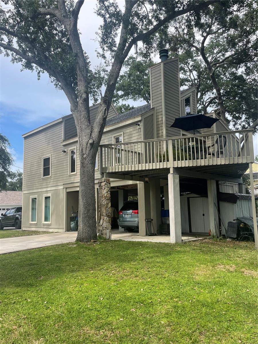Location! Location! Highly desired Seminole neighborhood. Just minutes from beach, parks, grocery and pharmacies, highly rated public schools and Seminole City Center. Unique contemporary designed home nestled in the shade among a dozen established live oak trees on an oversized lot (1.5x) of average size lot on the street. Deep back yard open for multiple opportunities for your personal desires - custom
pool, pickleball court, animal exercise area, putting green - to name a few. Constructed of Hardee board siding and hurricane rated windows. New roof installed and exterior painted in 2022. Open floor plan with 3/4” oak hardwood floors in living and dining room area, newly installed carpet in 3 bedrooms. Post and beam construction. Wood burning fireplace with vents. Ceiling fans throughout. Gorgeous granite countertops and movable island made of solid maple. Propane stove, water heater (replaced 2022), and dryer resulting in lower utility costs, especially in summer. Lots of natural light. An indoor jacuzzi tub on the main floor. Exterior stairwell was rebuilt in 2022 along with renovated deck. There is 662 sq ft of covered area under the 10’ high stilts with space for parking 2 vehicles plus added available space. Concrete driveway was replaced and extended in 2021. 8’ x 10’ storage shed under the deck. The 4th bedroom/office has a Murphy desk/bed on the ground level and was newly finished in 2022 and has it’s own private full bath and exterior entrance. The private deck off the living room extends your enjoyment of being outdoors. You will also enjoy many beautiful sunsets from there.